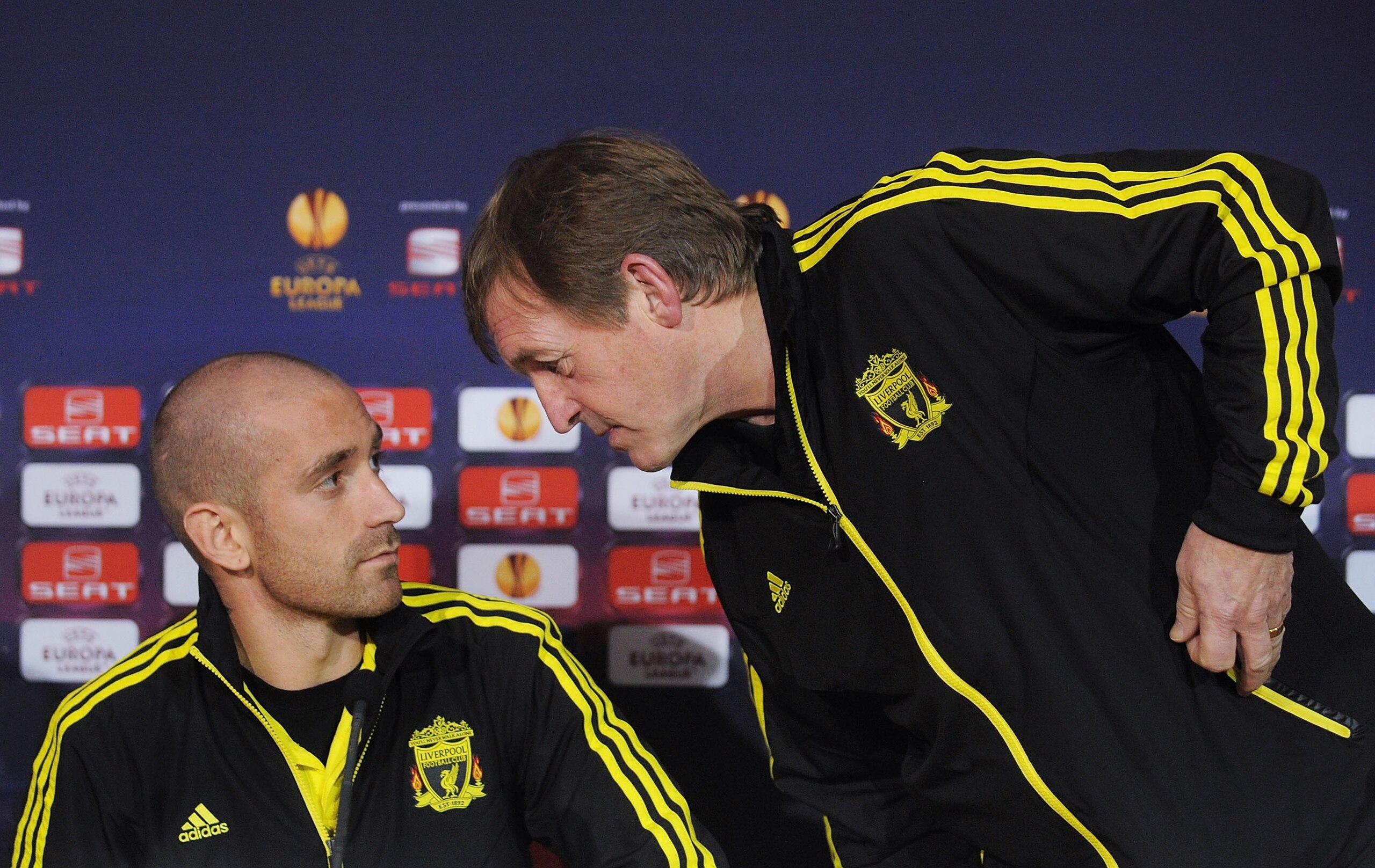 BRAGA, PORTUGAL - MARCH 09:  Manager Kenny Dalglish (R) speaks to Raul Meireles of Liverpool as they attend a press conference ahead of their UEFA Europa League Round of 16 match against Braga at Estadio Municipal de Braga on March 9, 2011 in Braga, Portu