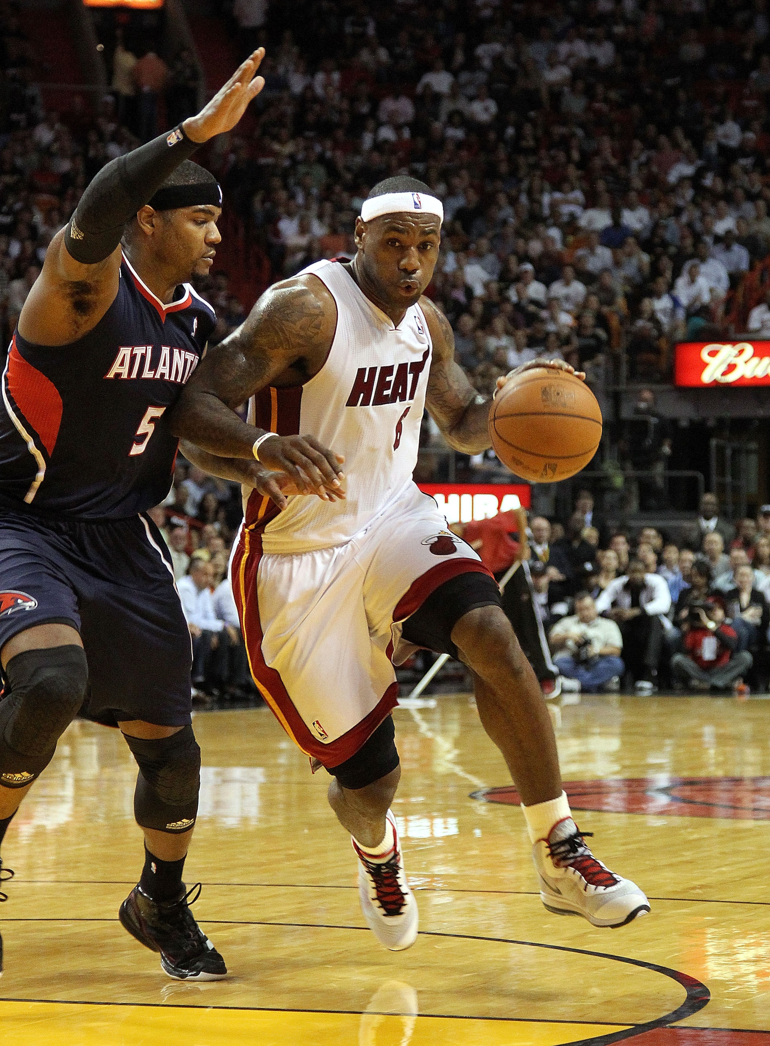 MIAMI, FL - JANUARY 18:  LeBron James #6 of the Miami Heat is guarded by Josh Smith #5 of the Atlanta Hawks during a game at American Airlines Arena on January 18, 2011 in Miami, Florida. NOTE TO USER: User expressly acknowledges and agrees that, by downl