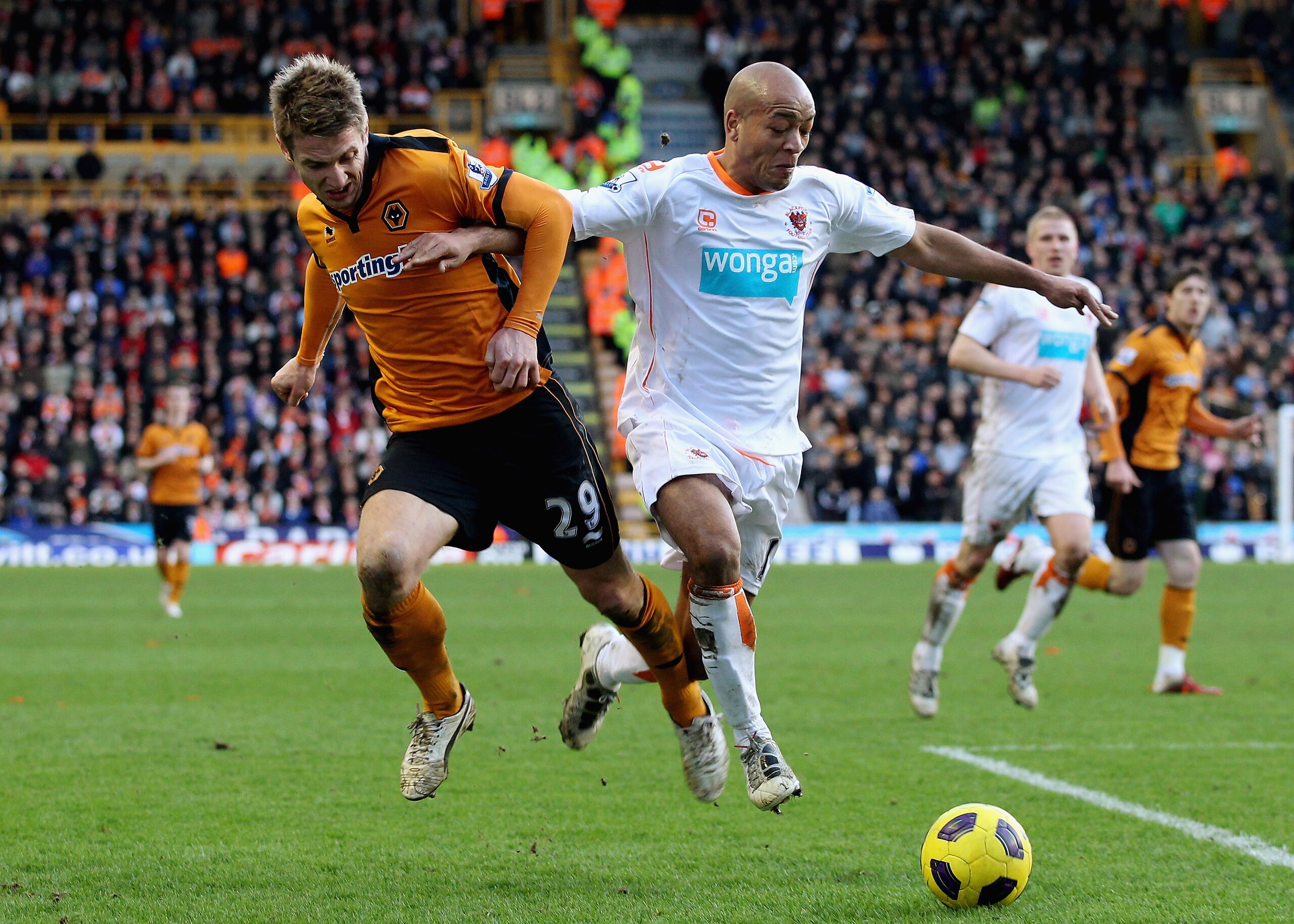 WOLVERHAMPTON, ENGLAND - FEBRUARY 26:  Kevin Doyle of Wolves (L) in action with Alex Baptiste of Blackpool during the Barclays Premier League match between Wolverhampton Wanderers and Blackpool at Molineux on February 26, 2011 in Wolverhampton, England.