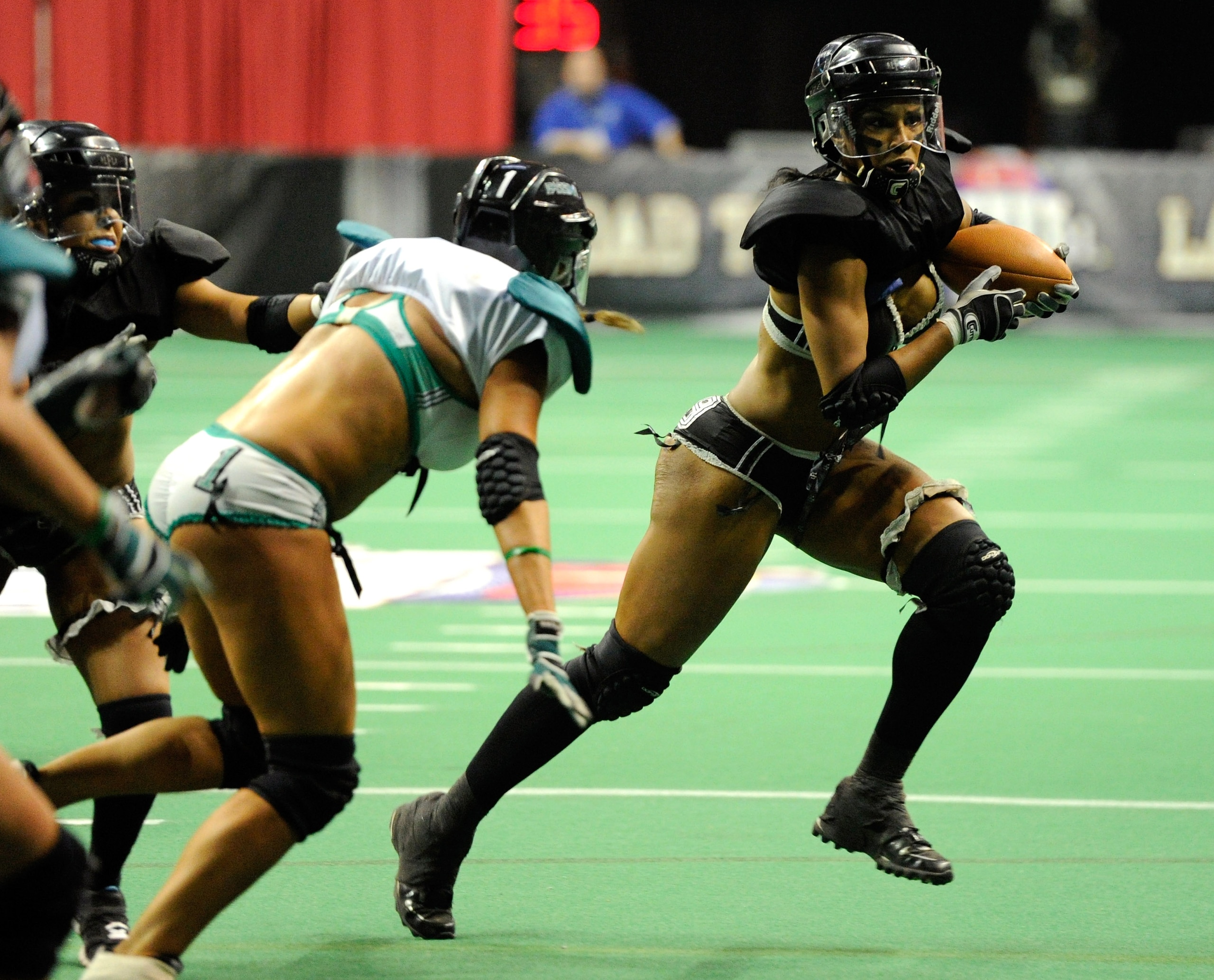 LAS VEGAS, NV - FEBRUARY 06:  Zipphora Chase #19 of the Los Angeles Temptation runs for yardage against the Philadelphia Passion during the Lingerie Football League's Lingerie Bowl VIII at the Thomas & Mack Center February 6, 2011 in Las Vegas, Nevada. Lo