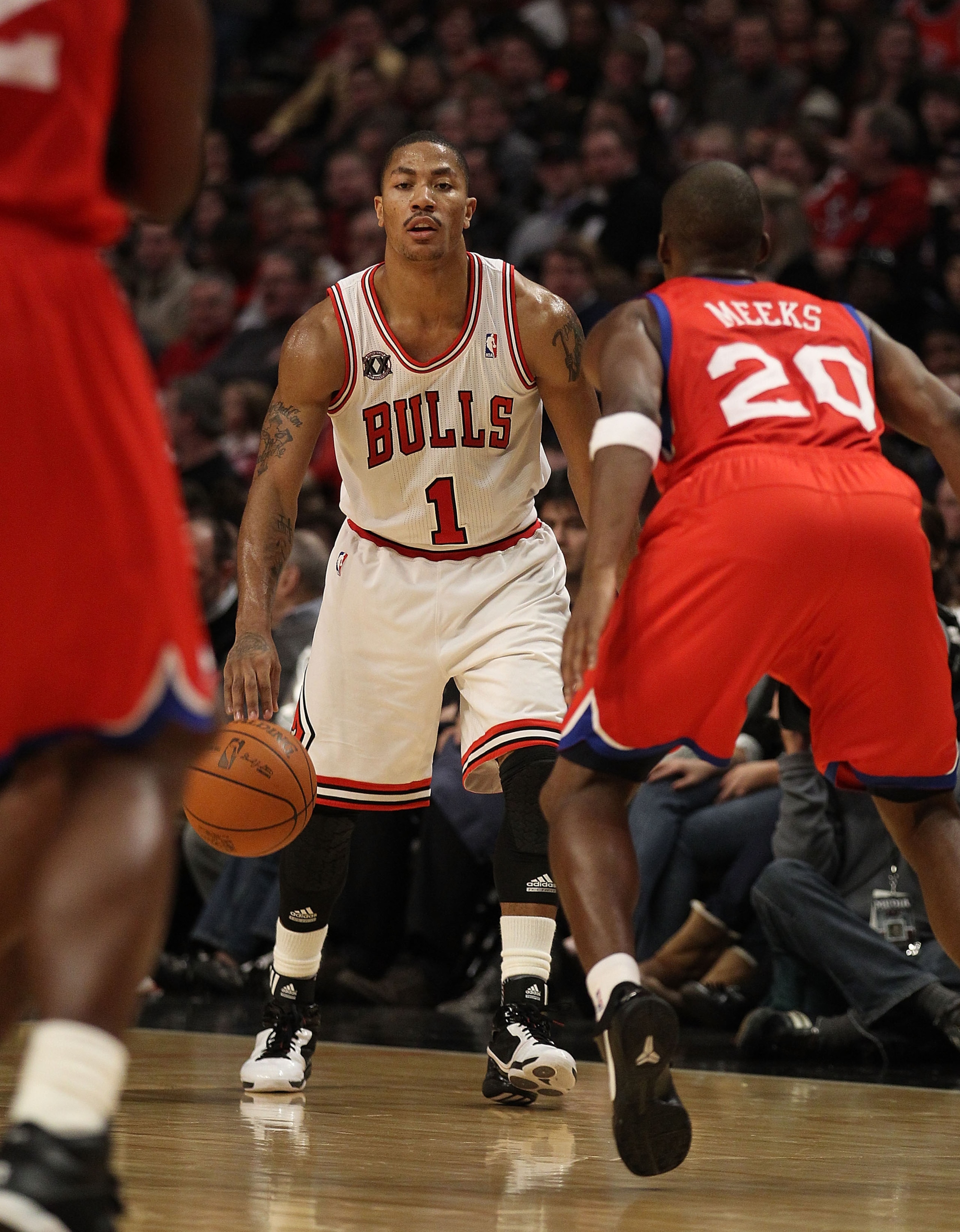 CHICAGO, IL - DECEMBER 21: Derrick Rose #1 of the Chicago Bulls moves against Jodie Meeks #20 of the Philadelphia 76ers at the United Center on December 21, 2010 in Chicago, Illinois. The Bulls defeated the 76ers 121-76. NOTE TO USER: User expressly ackno CHICAGO, IL - DECEMBER 21: Derrick Rose #1 of the Chicago Bulls moves against Jodie Meeks #20 of the Philadelphia 76ers at the United Center on December 21, 2010 in Chicago, Illinois. The Bulls defeated the 76ers 121-76. NOTE TO USER: User expressly ackno