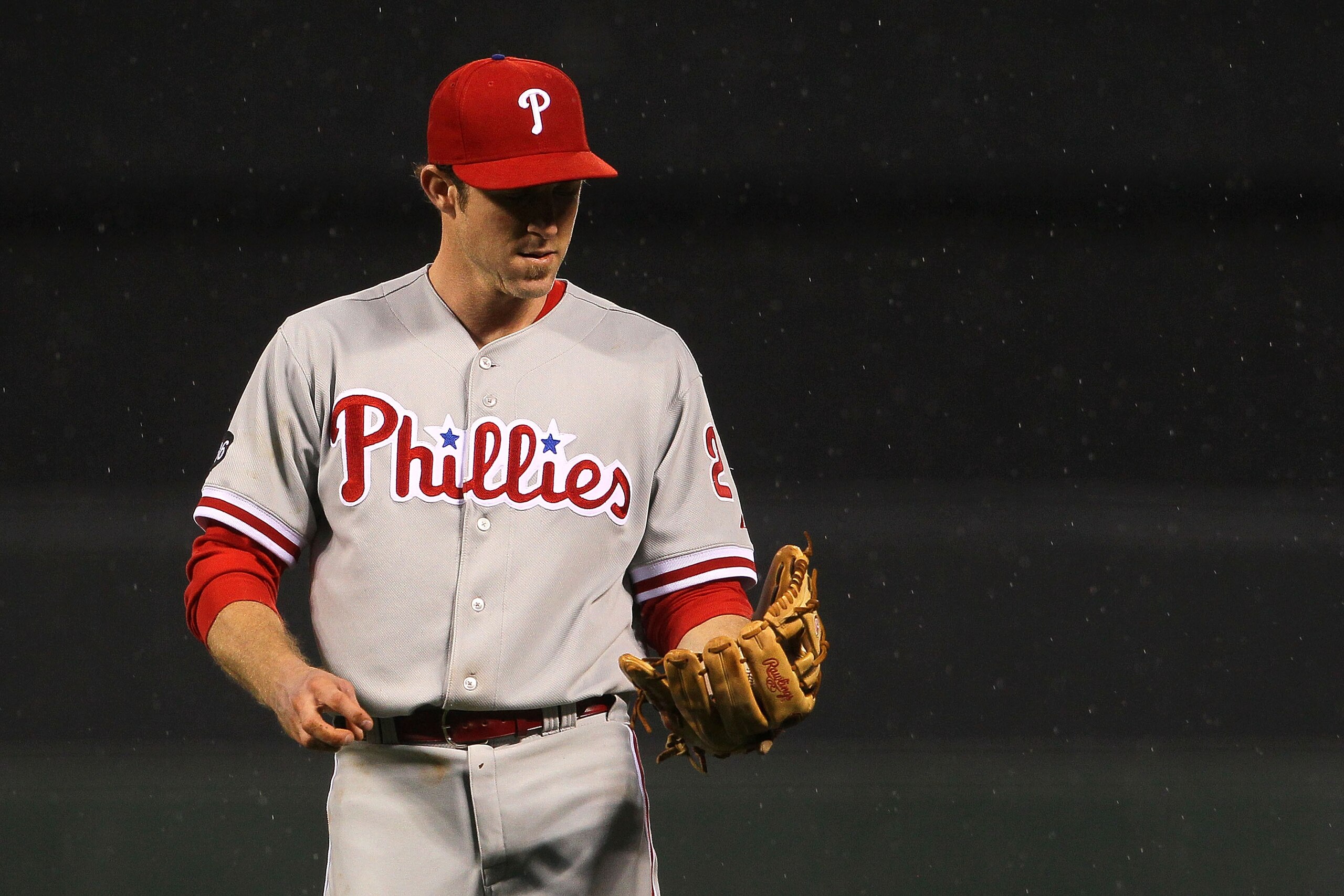 SAN FRANCISCO - OCTOBER 21:  Chase Utley #26 of the Philadelphia Phillies looks at his glove after making a play from second base while taking on the San Francisco Giants in Game Five of the NLCS during the 2010 MLB Playoffs at AT&T Park on October 21, 20