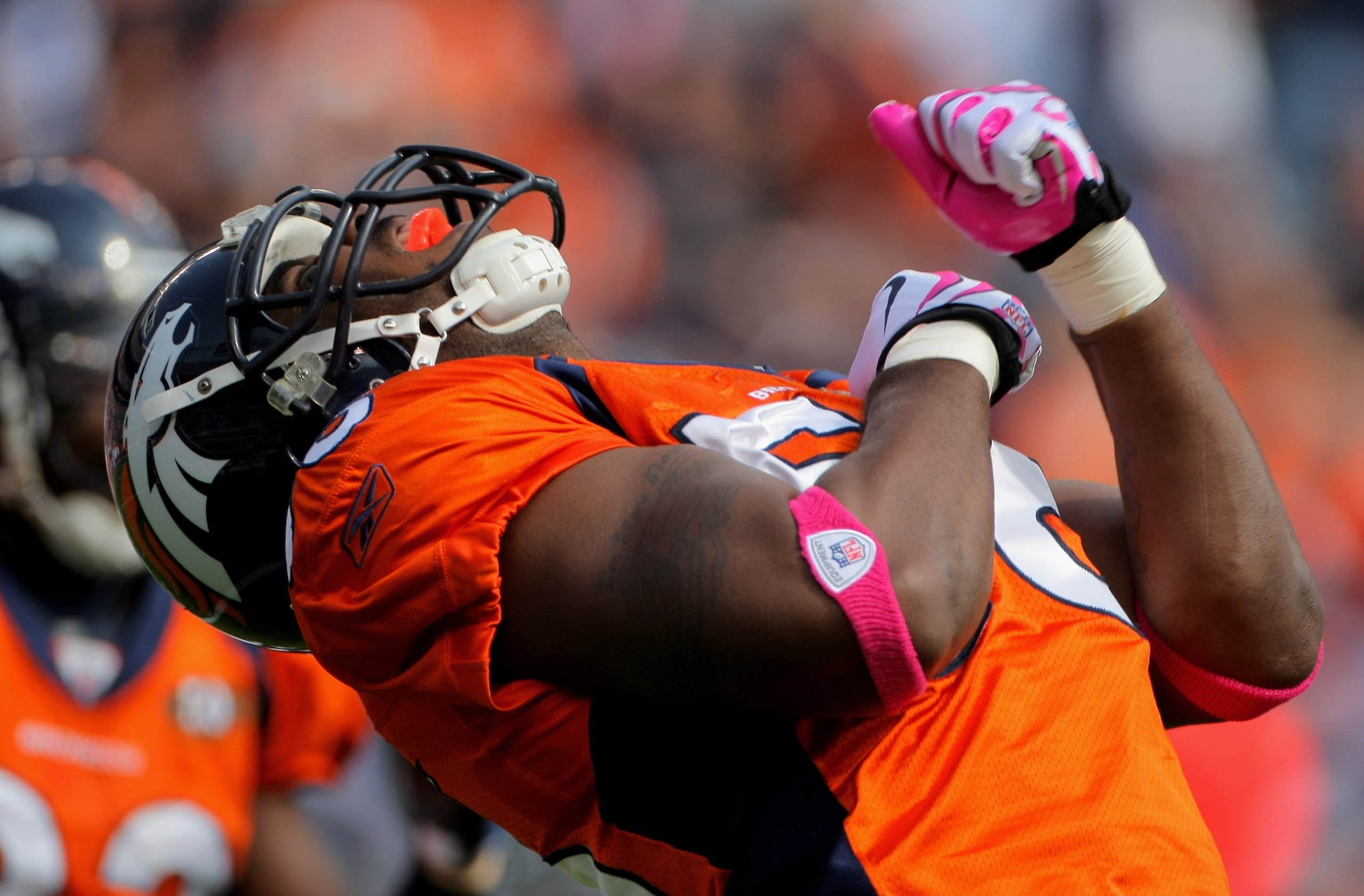 DENVER - OCTOBER 04:  Linebacker Robert Ayers #56 of the Denver Broncos celebrates a defensive play against the Dallas Cowboys during NFL action at Invesco Field at Mile High on October 4, 2009 in Denver, Colorado. The Broncos defeated the Cowboys 17-10.