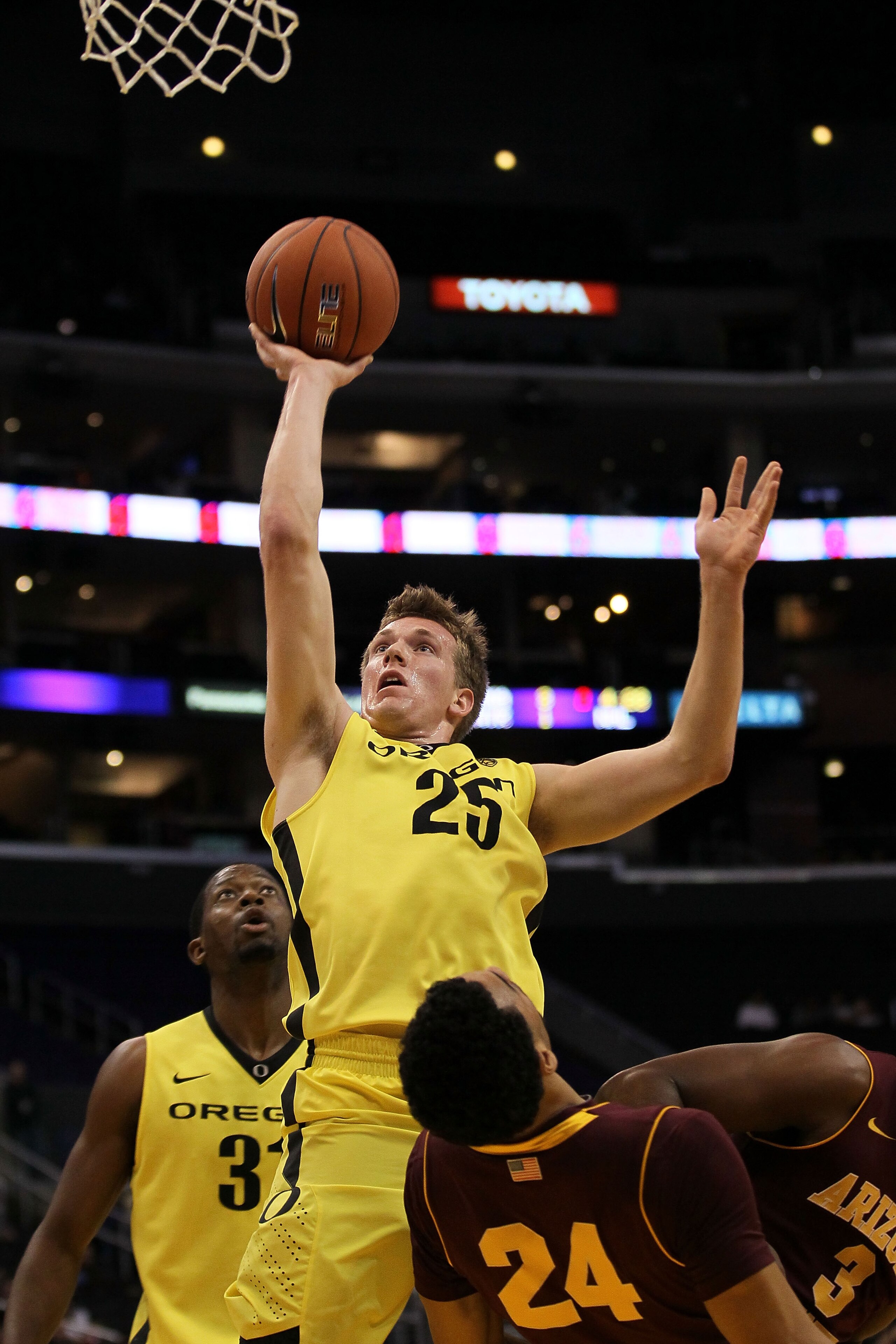 LOS ANGELES, CA - MARCH 09:  E.J. Singler #25 of the Oregon Ducks shoots over Trent Lockett #24 of the Arizona State Sun Devils in the first half in the first round of the 2011 Pacific Life Pac-10 Men's Basketball Tournament at Staples Center on March 9,