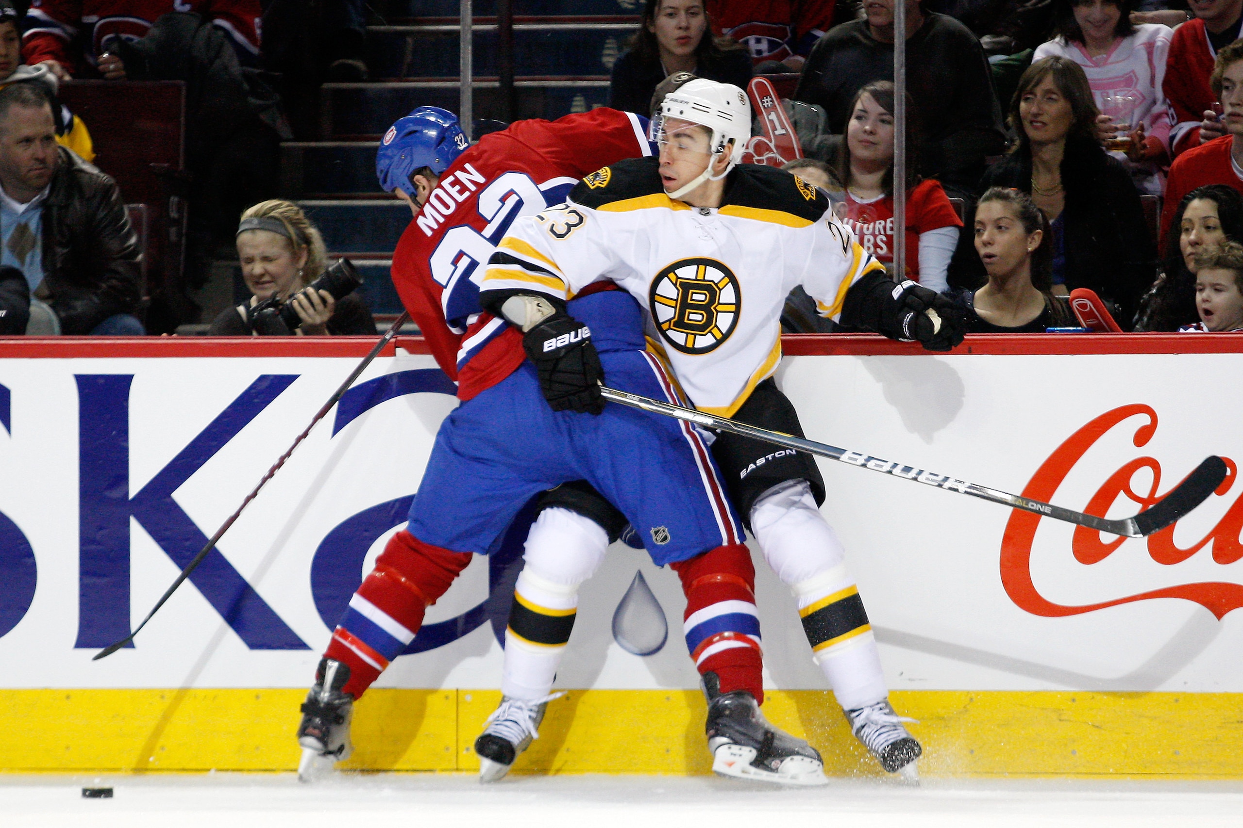 MONTREAL, CANADA - MARCH 8:  Chris Kelly #23 of the Boston Bruins and Travis Moen #32 of the Montreal Canadiens battle for the puck during the NHL game at the Bell Centre on March 8, 2011 in Montreal, Quebec, Canada.  (Photo by Richard Wolowicz/Getty Imag