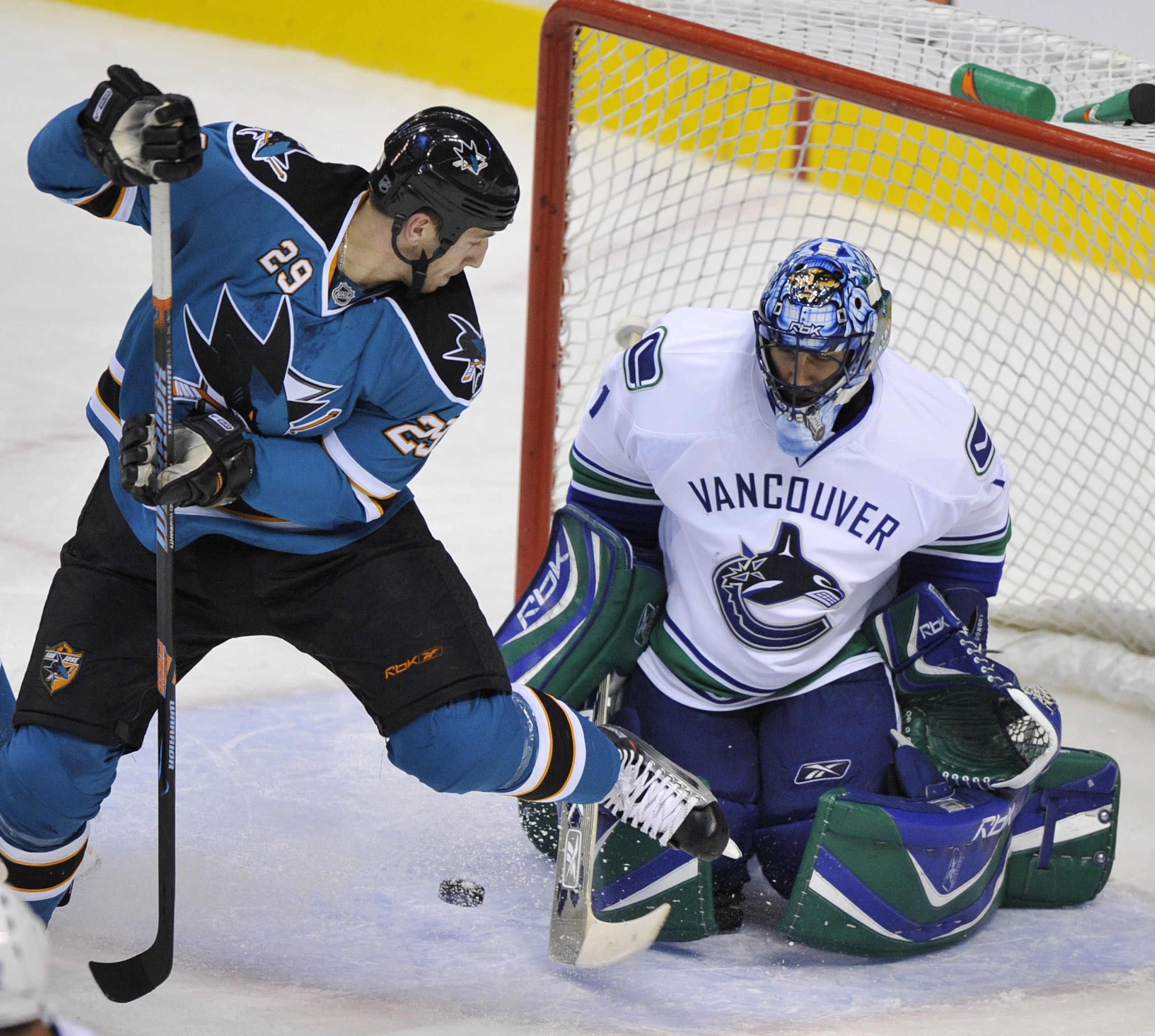 VANCOUVER, CANADA - OCTOBER 15:  Ryane Clowe #29 of the San Jose Sharks tries to back hand a shoot past goaltender Roberto Luongo #24 of the Vancouver Canucks during their game at General Motors Place October 15, 2007 in Vancouver, Canada.  (Photo by Nick