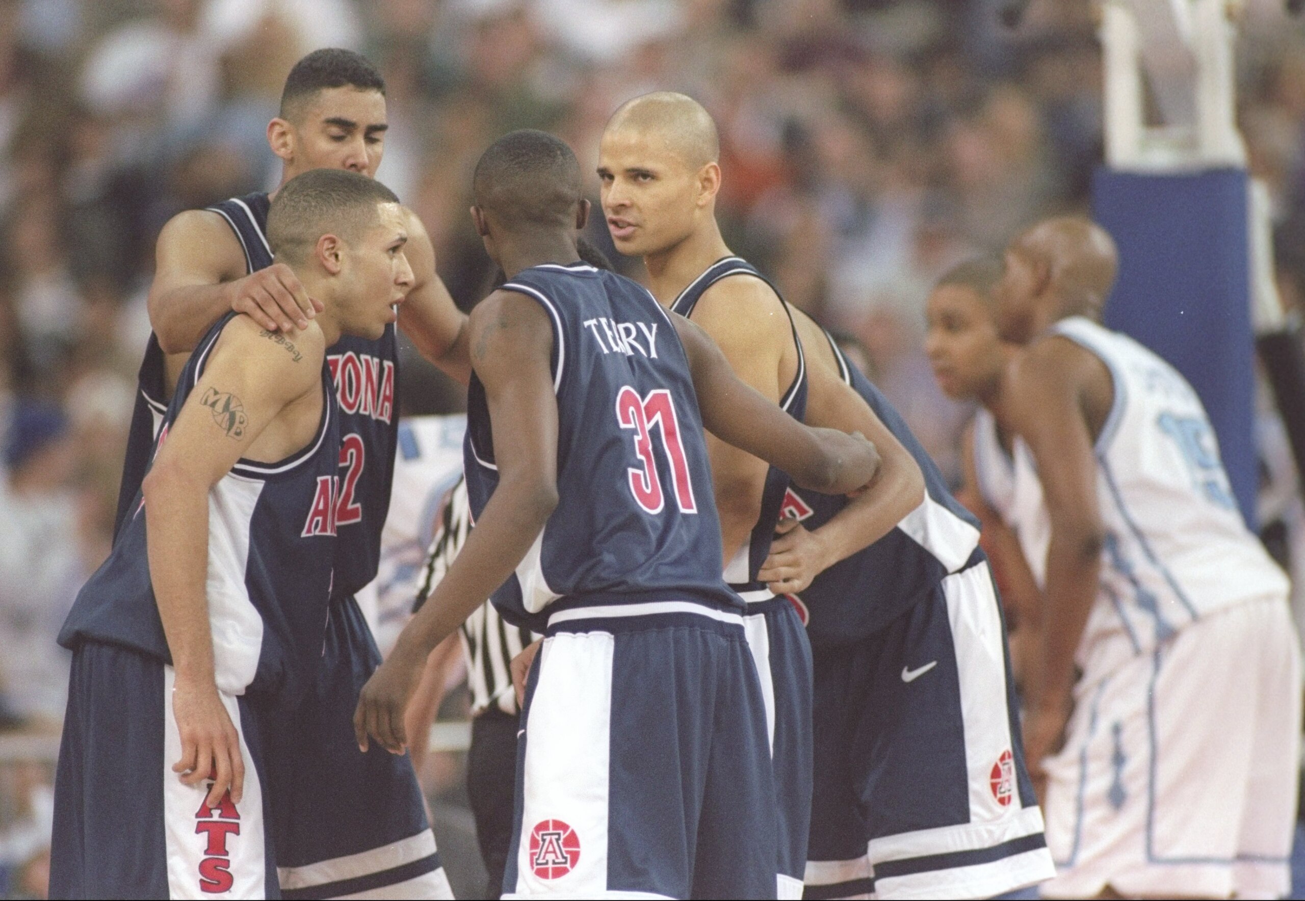 29 Mar 1997:  Guards Mike Bibby, Jason Terry and Miles Simon of the Arizona Wildcats speak to one another during an NCAA Final Four game against the North Carolina Tarheels at the RCA Dome in Indianapolis, Indiana.  Arizona won the game 66 - 58. Mandatory