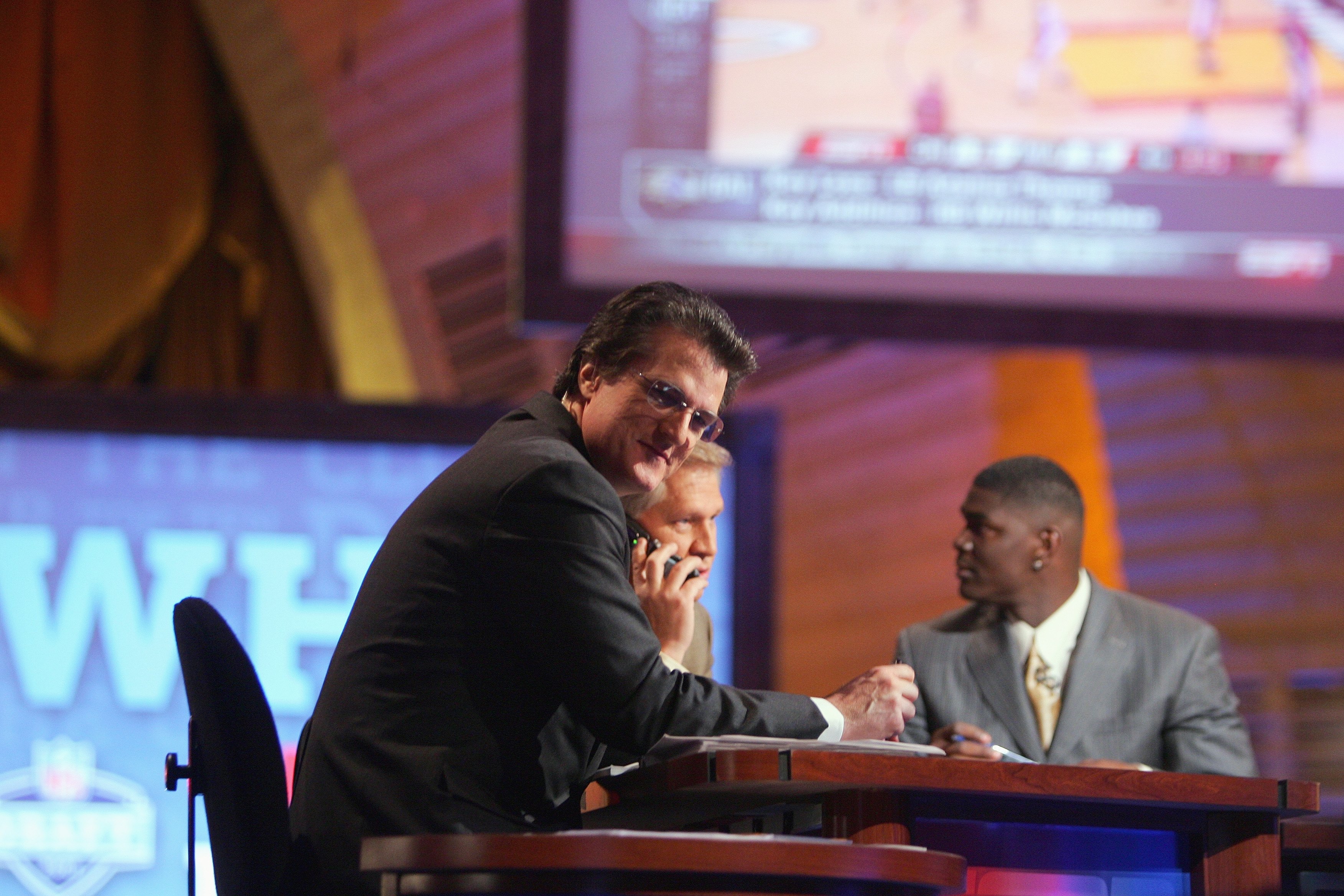NEW YORK - APRIL 28:  Mel Kiper, Chris Mortensen and Keyshawn Johnson broadcast for ESPN during the 2007 NFL Draft on April 28, 2007 at Radio City Music Hall in New York, New York. (Photo by Chris McGrath/Getty Images)