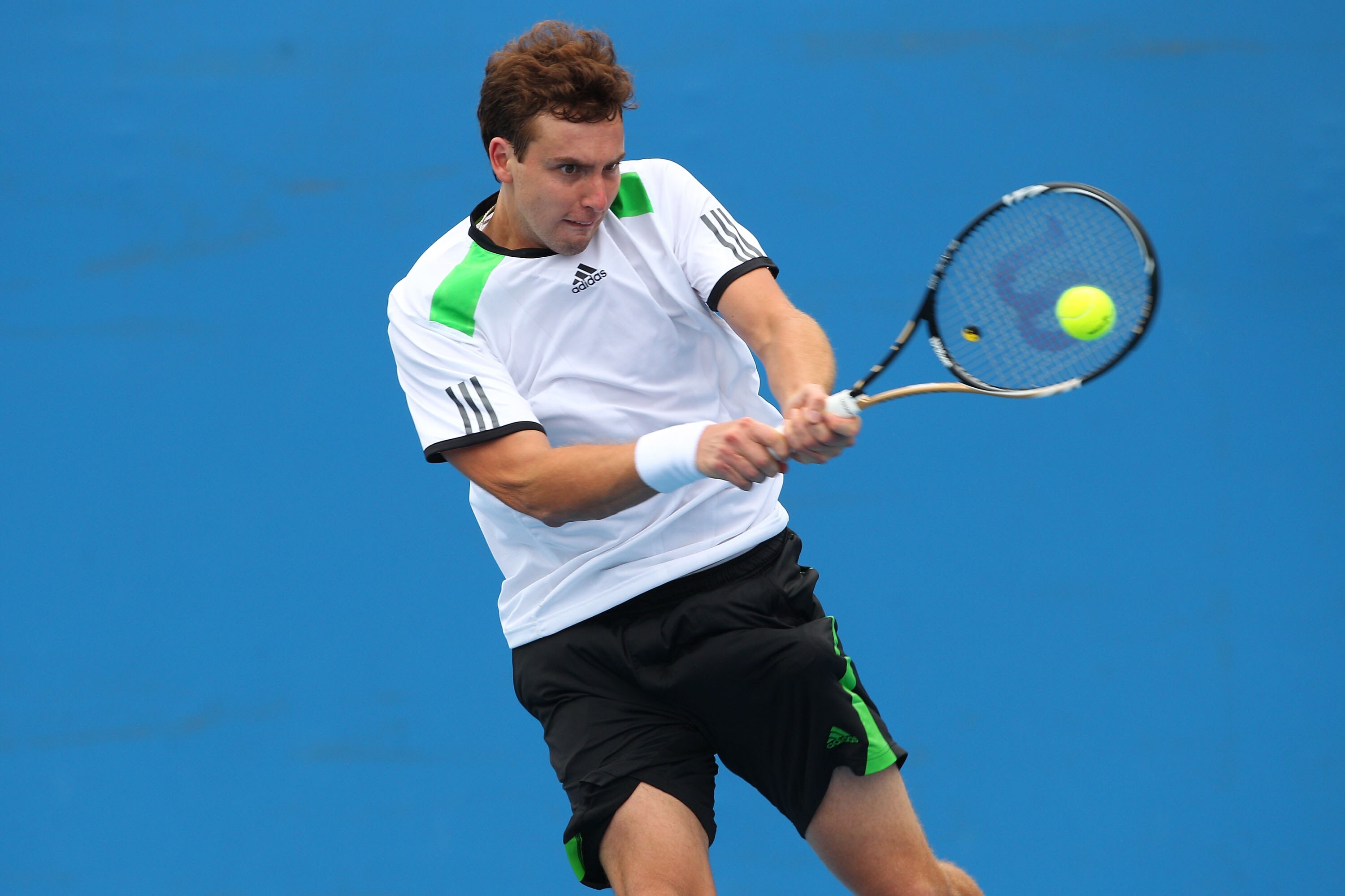 MELBOURNE, AUSTRALIA - JANUARY 18:  Ernests Gulbis of Latvia plays a backhand in his first round match against Benjamin Becker of Germany  during day two of the 2011 Australian Open at Melbourne Park on January 18, 2011 in Melbourne, Australia.  (Photo by
