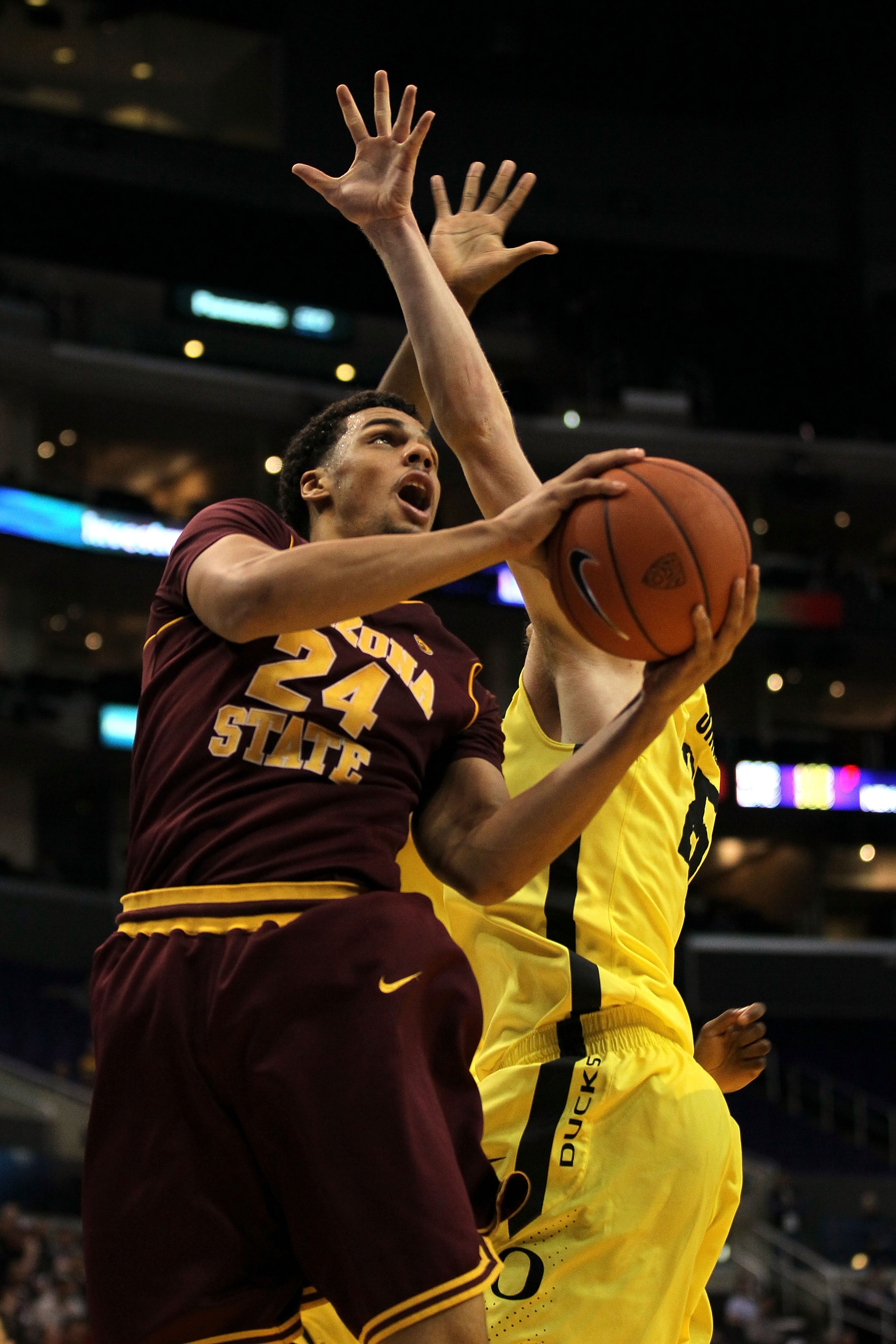 LOS ANGELES, CA - MARCH 09:  Trent Lockett #24 of the Arizona State Sun Devils goes up for a shot against E.J. Singler #25 of the Oregon Ducks in the second half in the first round of the 2011 Pacific Life Pac-10 Men's Basketball Tournament at Staples Cen