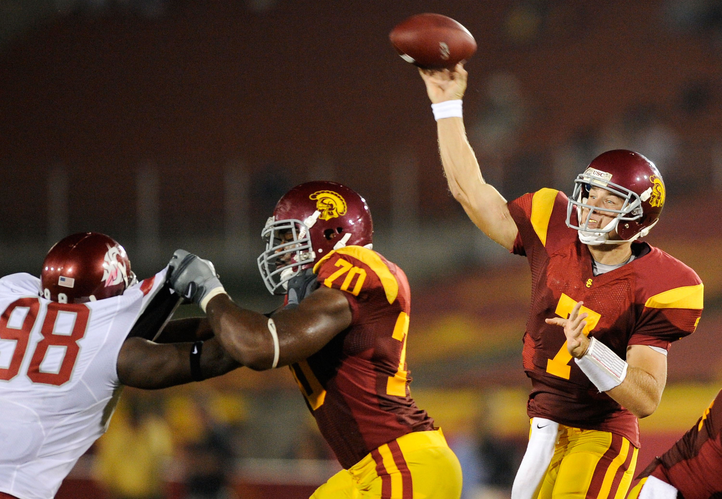 LOS ANGELES, CA - SEPTEMBER 26:   Quarterback Matt Barkley #7 of the USC Trojans throws a pass as Tyron Smith #70 blocks Jesse Feagin #98 of  the Washington State Cougars during the second quarter of the college football game at the Los Angeles Memorial C