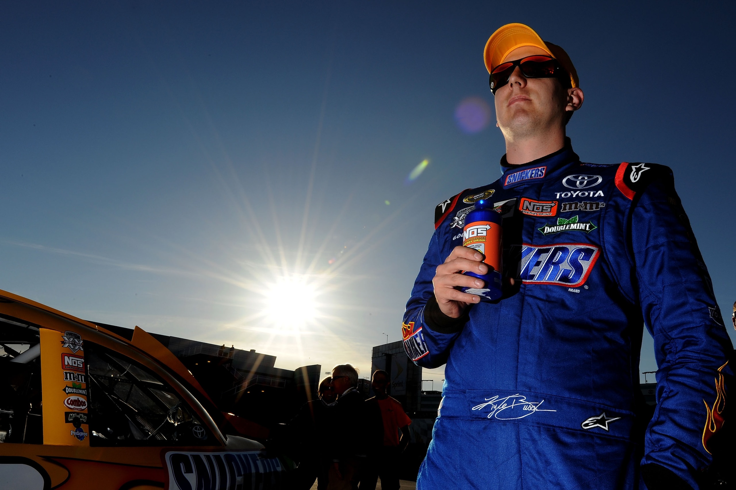 LAS VEGAS, NV - MARCH 04:  Kyle Busch, driver of the #18 Snickers Peanut Butter Squared Toyota, stands in the garage area after qualifying for the NASCAR Sprint Cup Series Kobalt Tools 400 at Las Vegas Motor Speedway on March 4, 2011 in Las Vegas, Nevada.