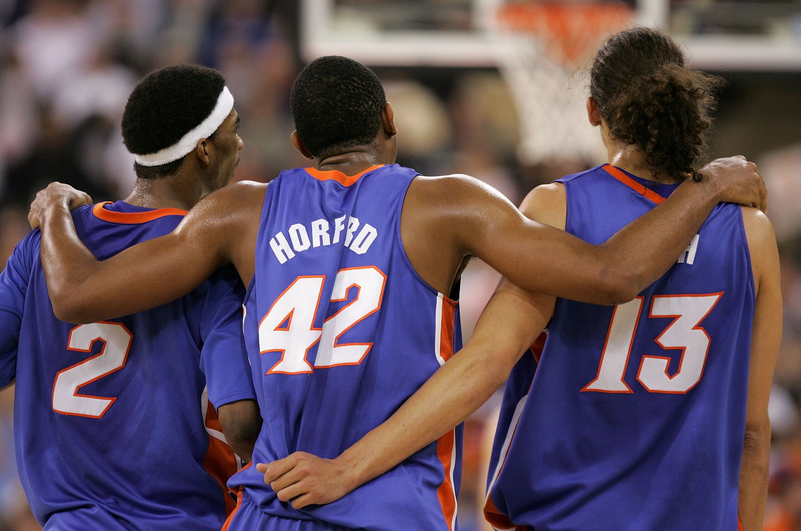 INDIANAPOLIS - APRIL 03:  Al Horford #42 puts his arms around teammates Corey Brewer #2 and Joakim Noah #13 of the Florida Gators as they celebrate in the final seconds of the game before defeating the UCLA Bruins 73-57 during the National Championship ga