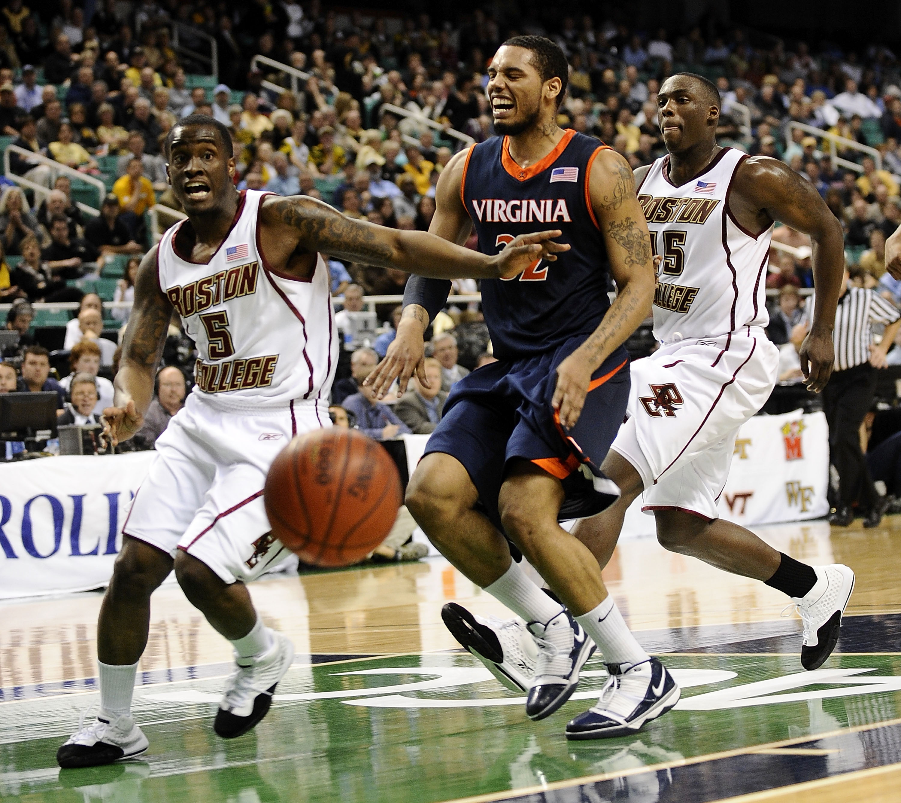 GREENSBORO, NC - MARCH 11:  Biko Paris #5 and Cortney Dunn #55 of the Boston College Eagles chase Mike Scott #32 of the University of Virginia Cavaliers in their first round game in the 2010 ACC Men's Basketball Tournament at the Greensboro Coliseum on Ma