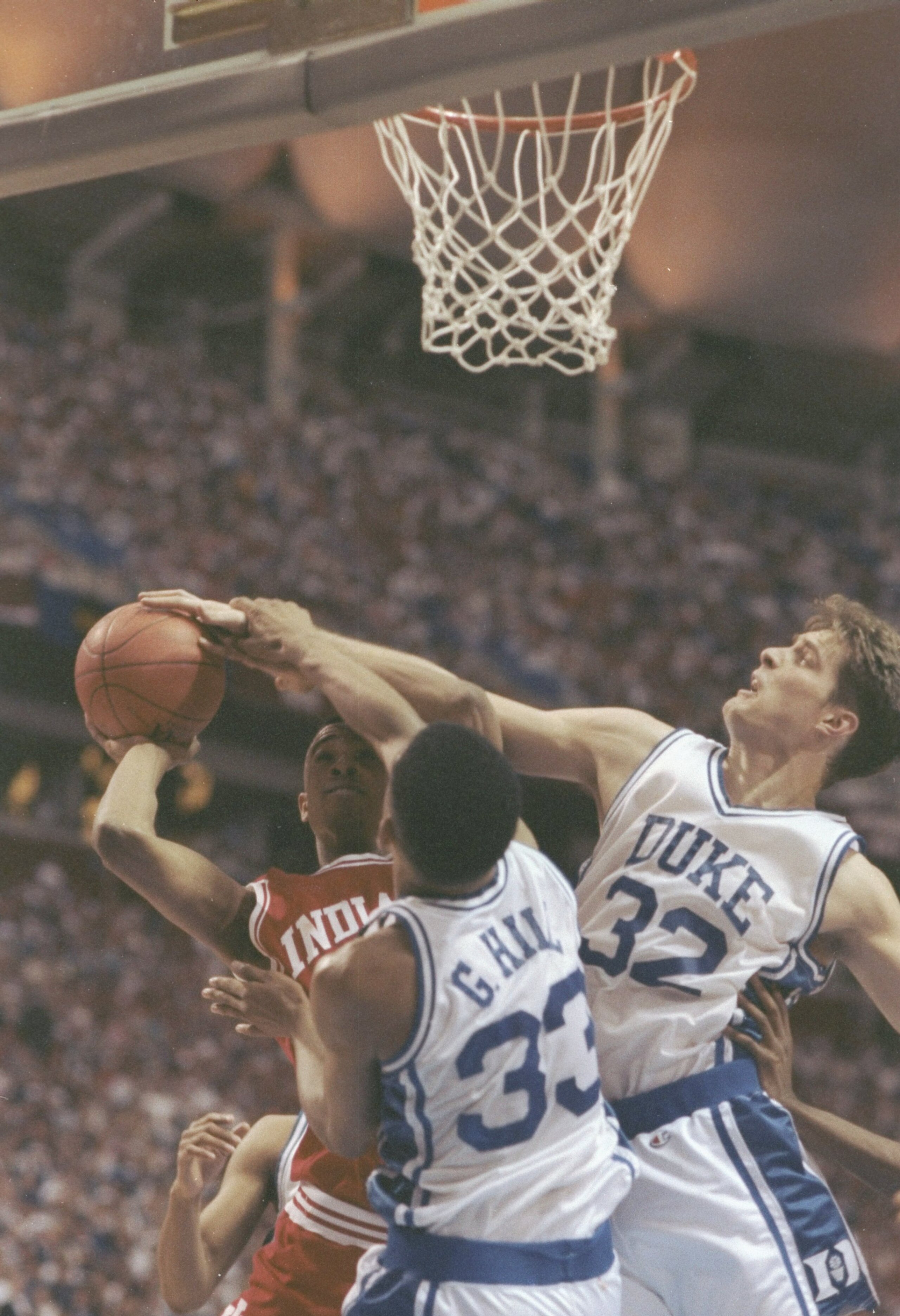 4 Apr 1992:  Alan Henderson of the Indiana Hoosiers tries to shoot the ball over center Christian Laettner and forward Grant Hill of the Duke Blue Devils during a playoff game at the Hubert H. Humphrey Metrodome in Minneapolis, Minnesota.  Duke won the ga