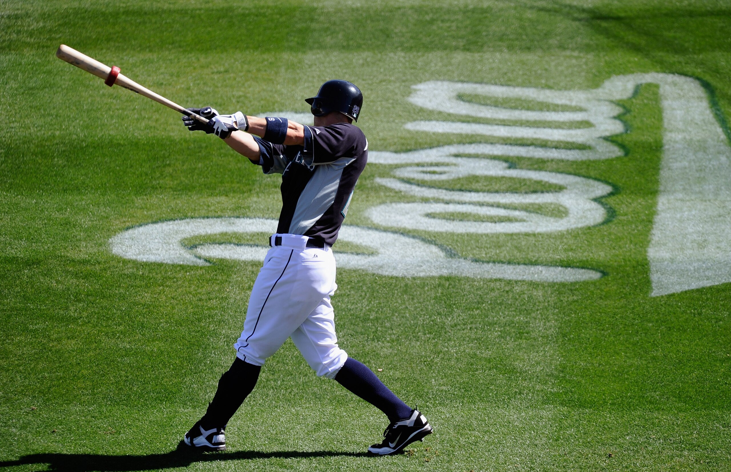 PEORIA, AZ - MARCH 08:  Brendan Ryan #26 of the Seattle Mariners swings the bat near the on deck circle during the spring training baseball game against the San Francisco Giants at Peoria Stadium on March 8, 2011 in Peoria, Arizona.  (Photo by Kevork Djan