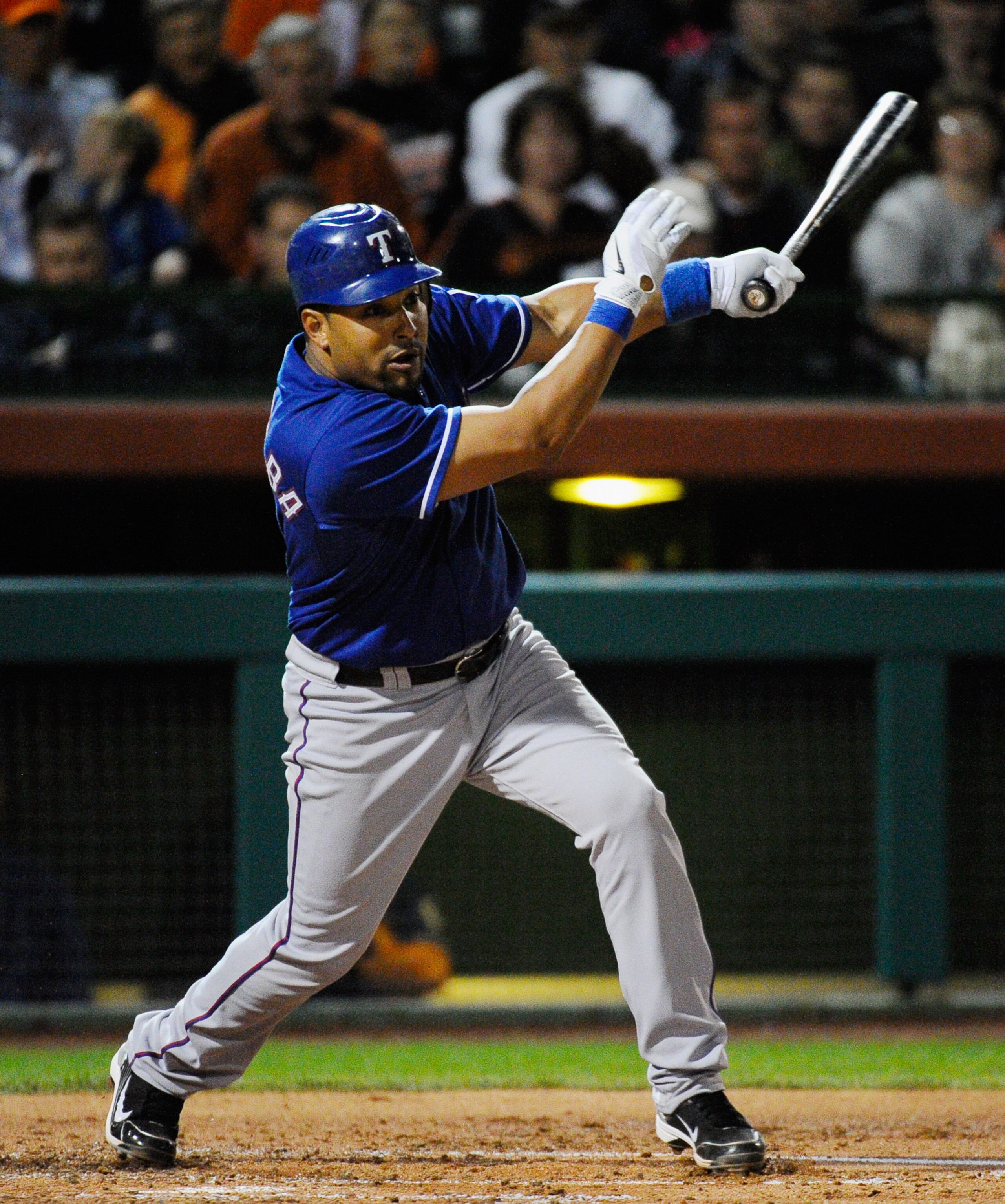 SCOTTSDALE, AZ - MARCH 07:  Yorvit Torrealba #8 of the Texas Rangers hits a one run double against the San Francisco Giants to score teammate Michael Young in the first meeting between the two teams since the World Series during the spring training game a