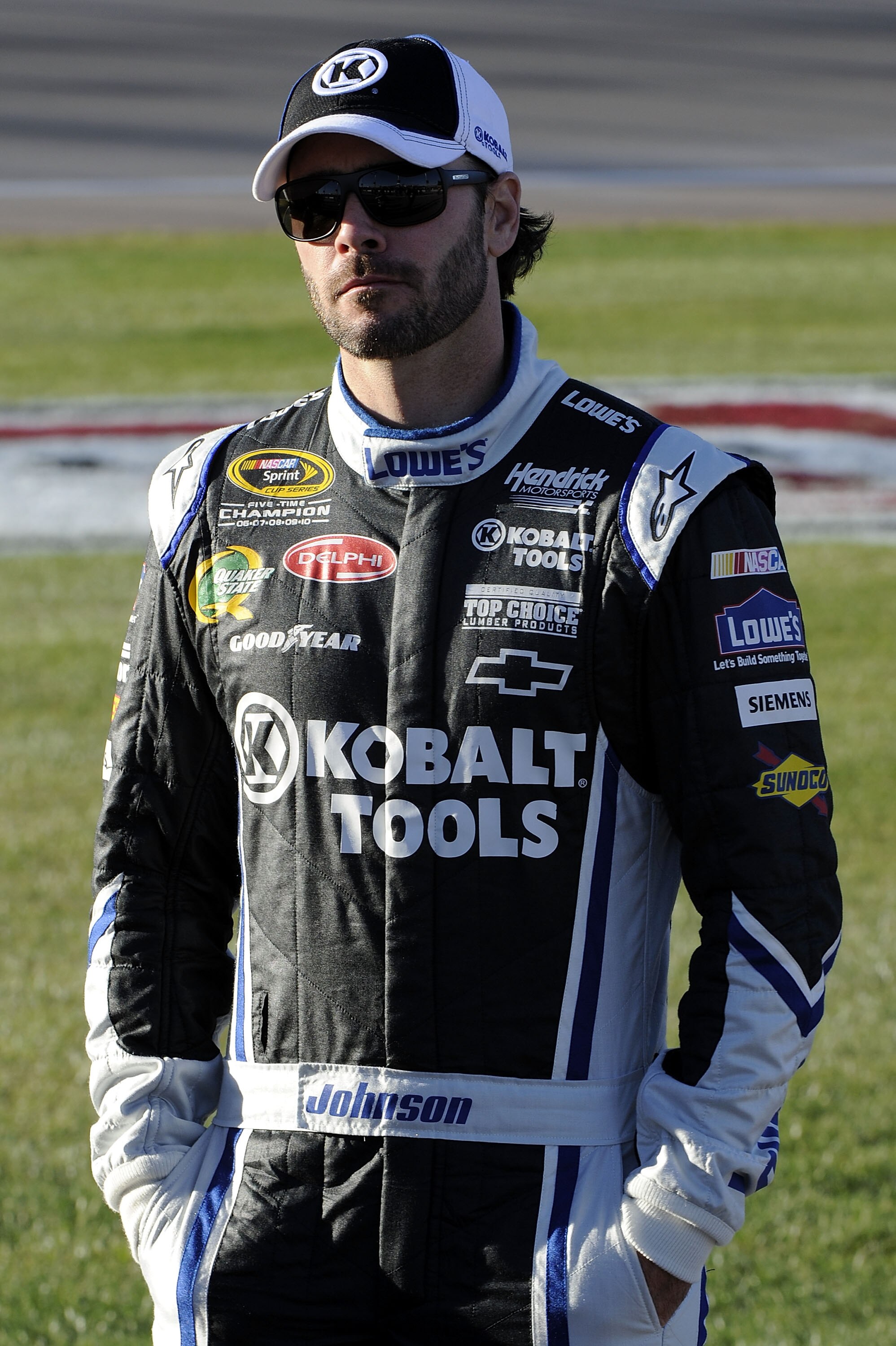 LAS VEGAS, NV - MARCH 04:  Jimmie Johnson, driver of the #48 Lowe's Chevrolet, stands on the grid during qualifying for the NASCAR Sprint Cup Series Kobalt Tools 400 at Las Vegas Motor Speedway on March 4, 2011 in Las Vegas, Nevada.  (Photo by John Harrel