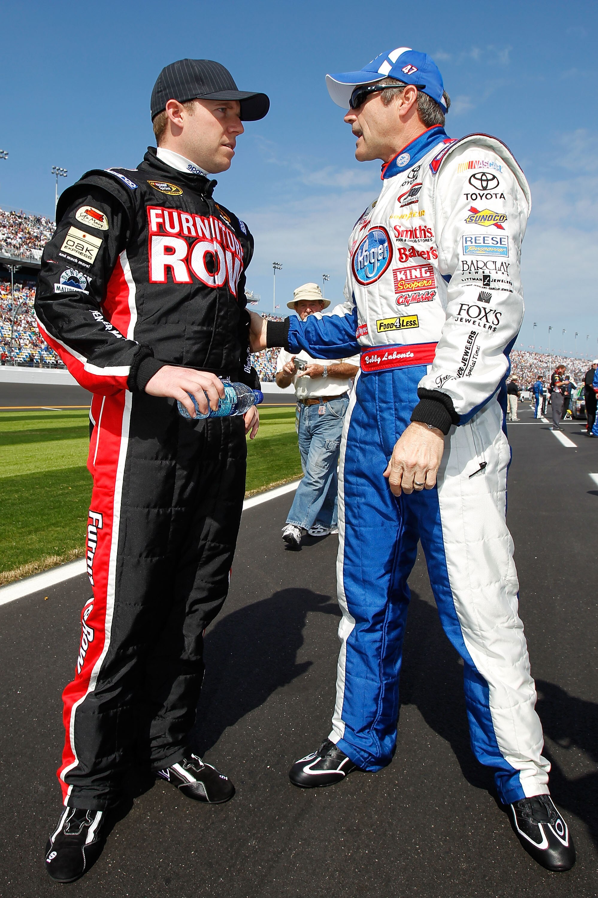 DAYTONA BEACH, FL - FEBRUARY 17:  Regan Smith, driver of the #78 Furniture Row Racing Chevrolet, talks to Bobby Labonte, driver of the #47 Kroger/USO Toyota, on the grid prior to the first race of the NASCAR Sprint Cup Series Gatorade Duel at Daytona Inte