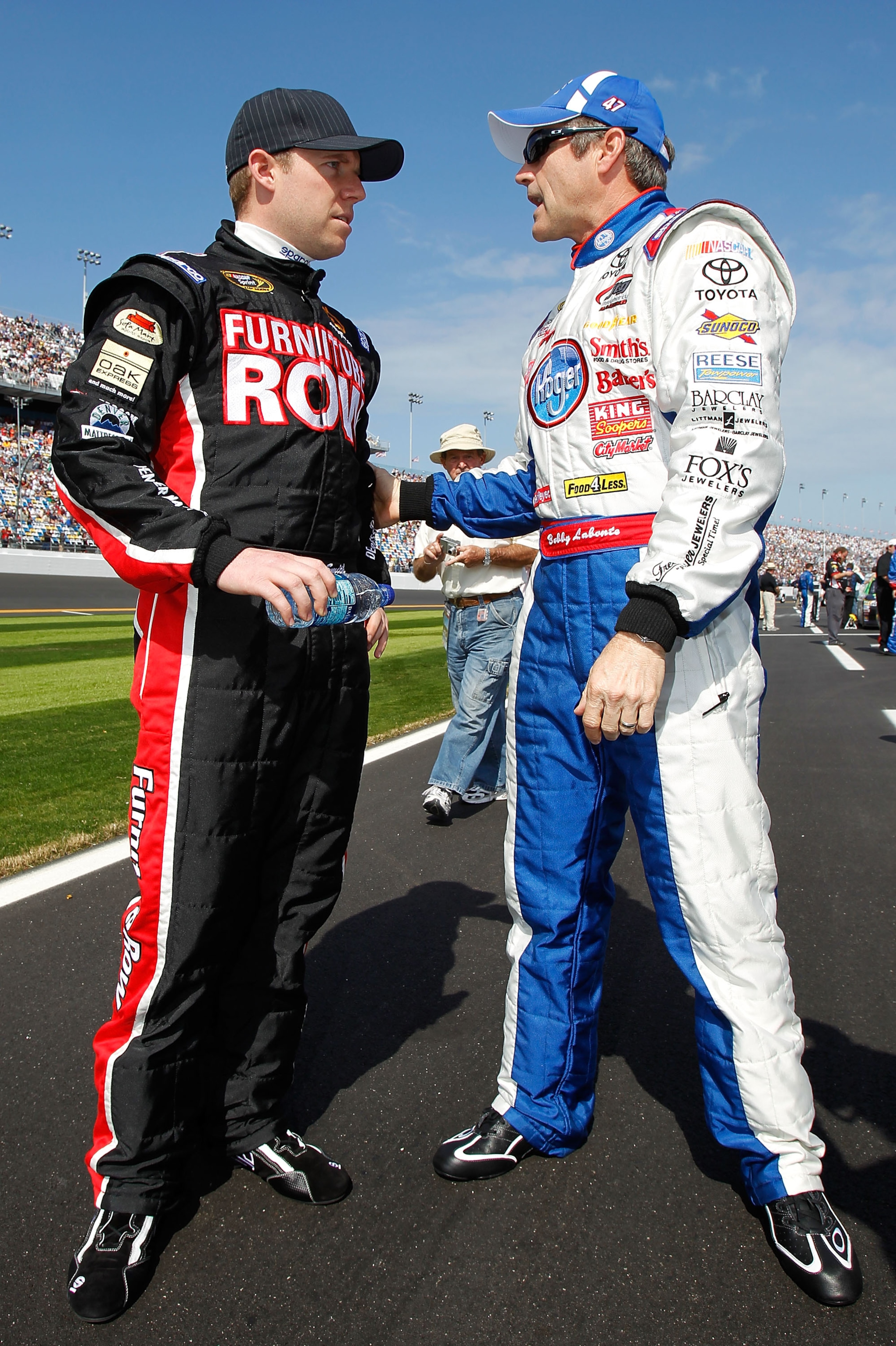 DAYTONA BEACH, FL - FEBRUARY 17:  Regan Smith, driver of the #78 Furniture Row Racing Chevrolet, talks to Bobby Labonte, driver of the #47 Kroger/USO Toyota, on the grid prior to the first race of the NASCAR Sprint Cup Series Gatorade Duel at Daytona Inte