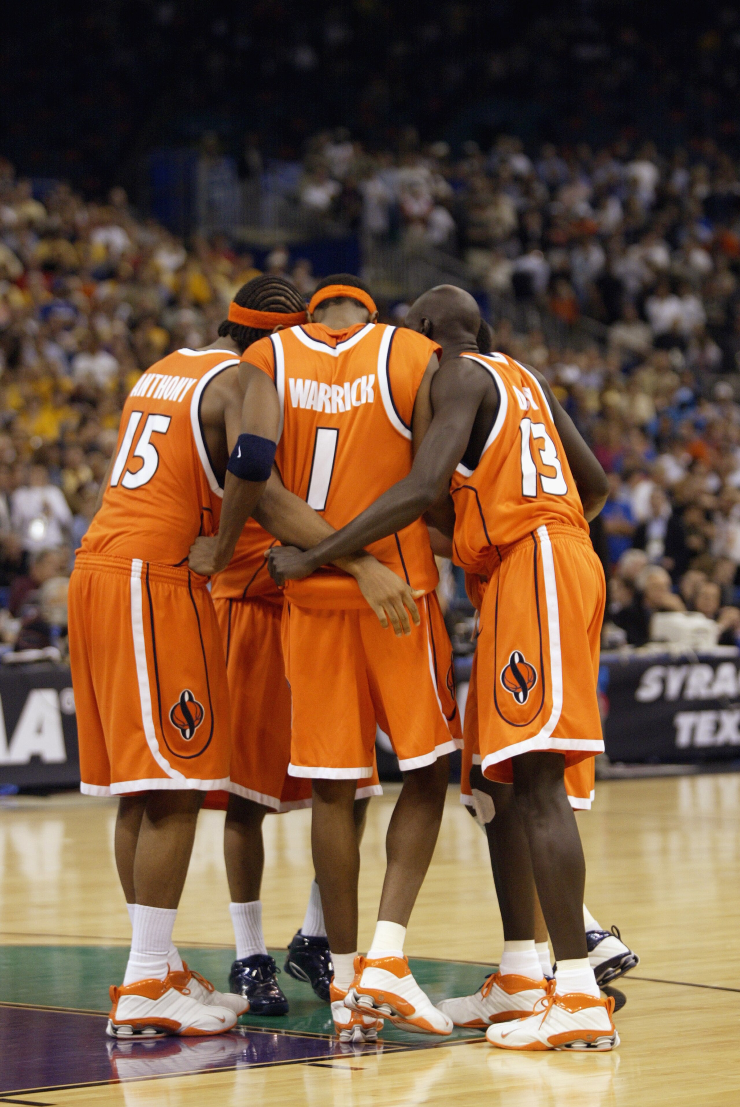 NEW ORLEANS - APRIL 7:  Carmelo Anthony #15, Hakim Warrick #1, Kueth Duany #13 and two teammates all of Syracuse huddle on the floor against Kansas during the championship game of the NCAA Men's Final Four Tournament on April 7, 2003 at the Louisiana Supe