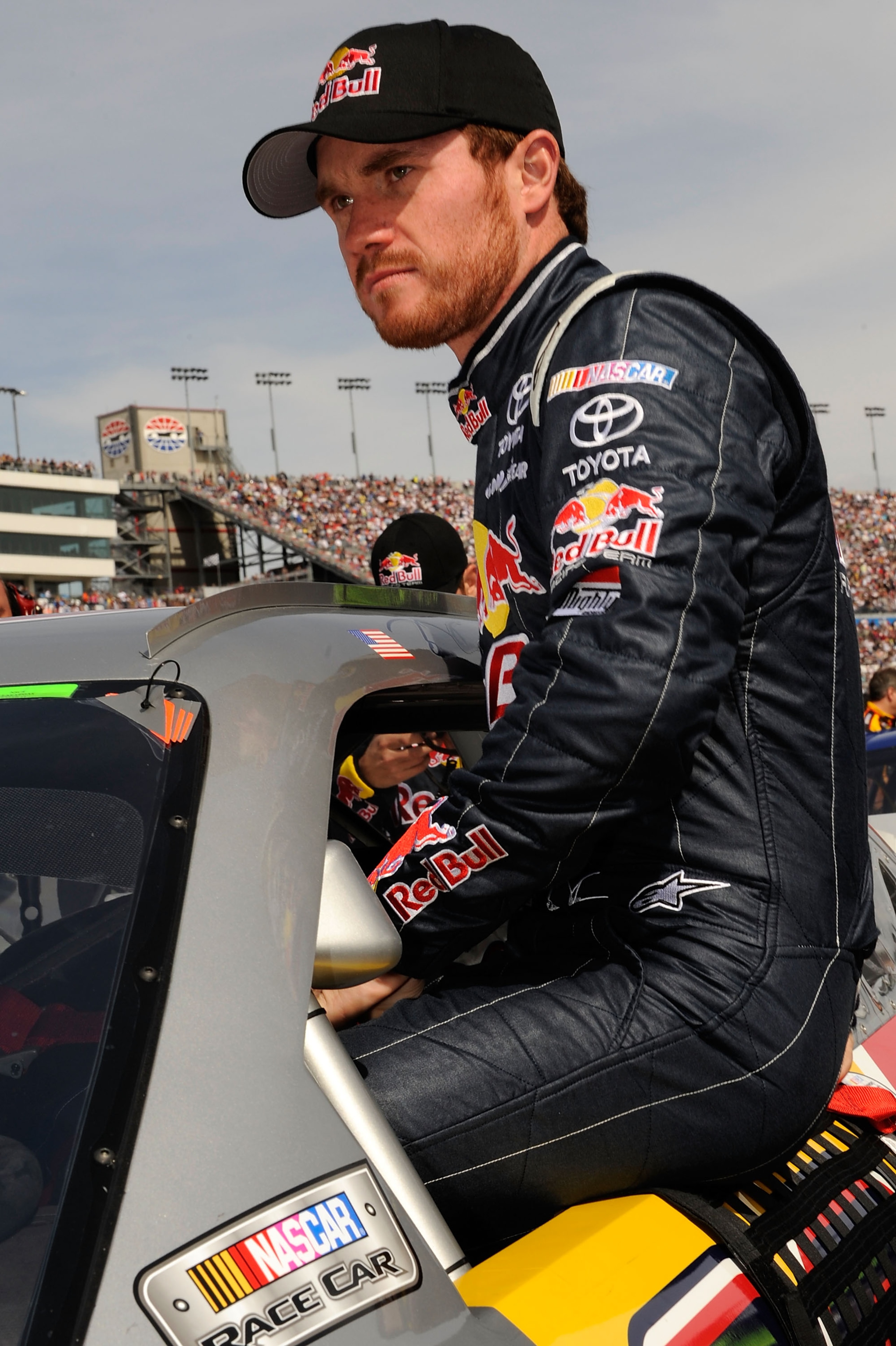 LAS VEGAS, NV - MARCH 06:  Brian Vickers, driver of the #83 Red Bull Toyota, climbs in his car on the grid prior to the NASCAR Sprint Cup Series Kobalt Tools 400 at Las Vegas Motor Speedway on March 6, 2011 in Las Vegas, Nevada.  (Photo by John Harrelson/