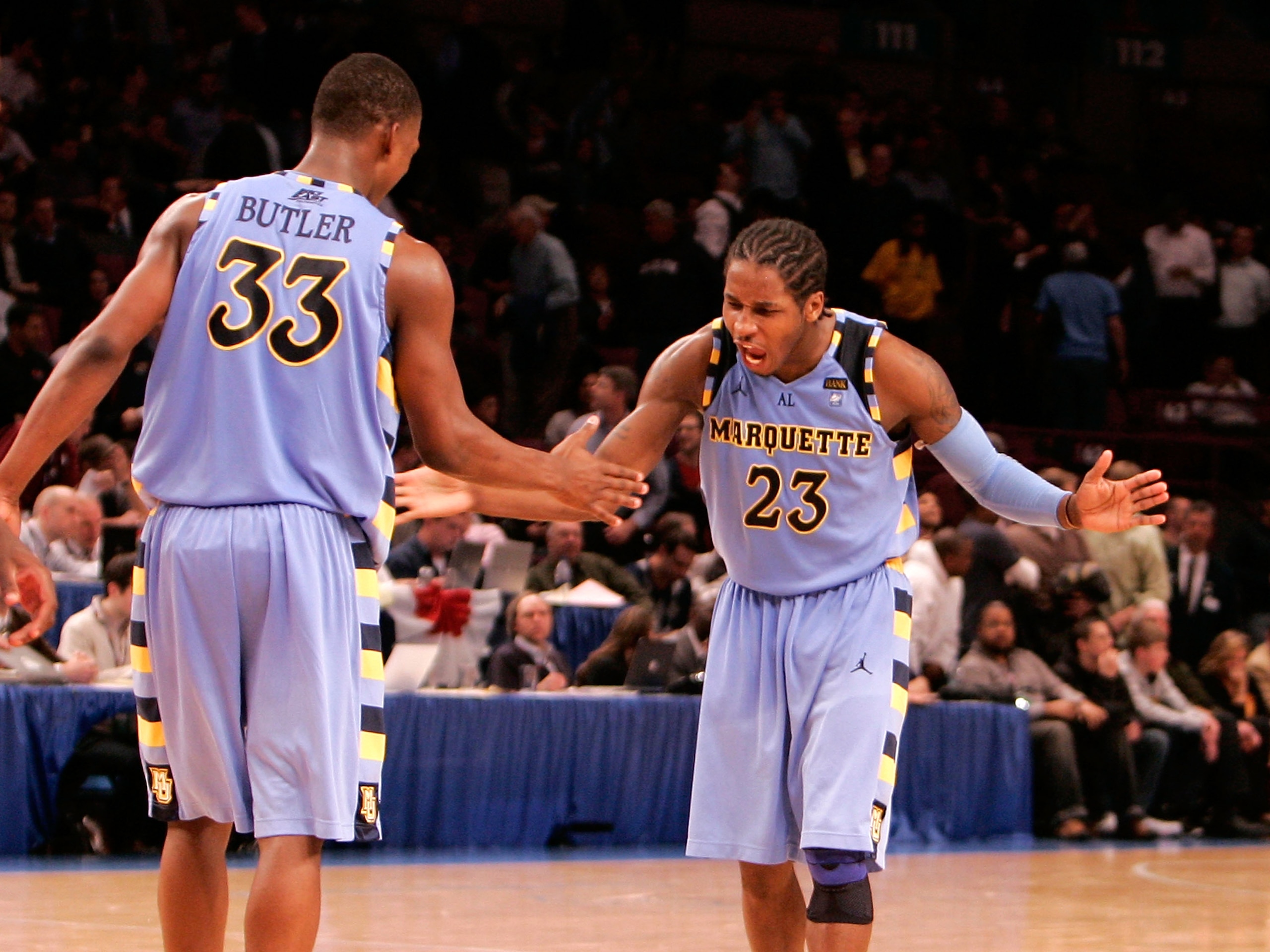 NEW YORK, NY - MARCH 09: Dwight Buycks #23 and Jimmy Butler #33 of the Marquette Golden Eagles celebrate late in the second half against the West Virginia Mountaineers during the second round of the 2011 Big East Men's Basketball Tournament presented by A