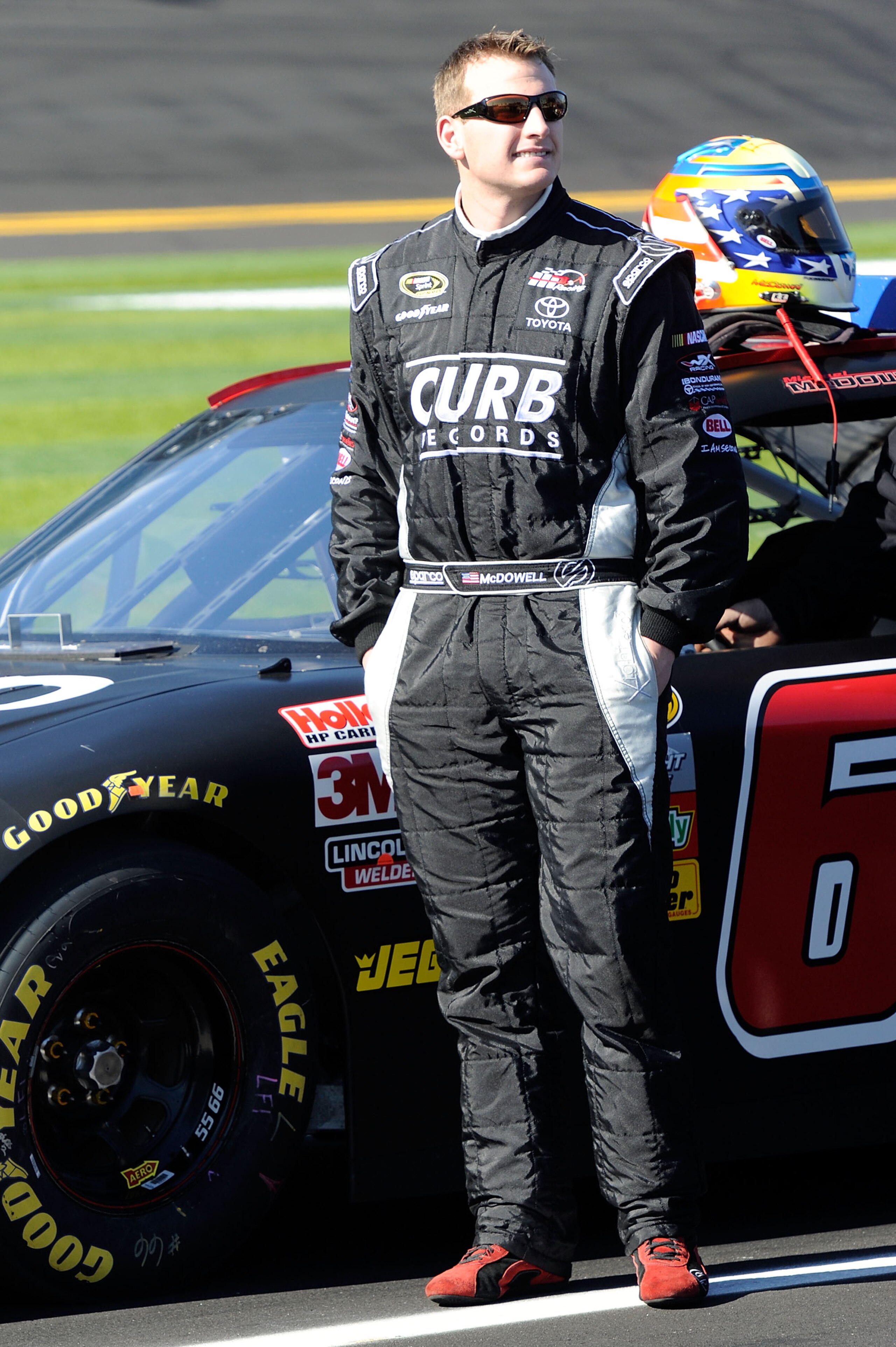 DAYTONA BEACH, FL - FEBRUARY 13:  Michael McDowell, driver of the #66 HP Racing Toyota, stands on the grid during qualifying for the NASCAR Sprint Cup Series Daytona 500 at Daytona International Speedway on February 13, 2011 in Daytona Beach, Florida.  (P