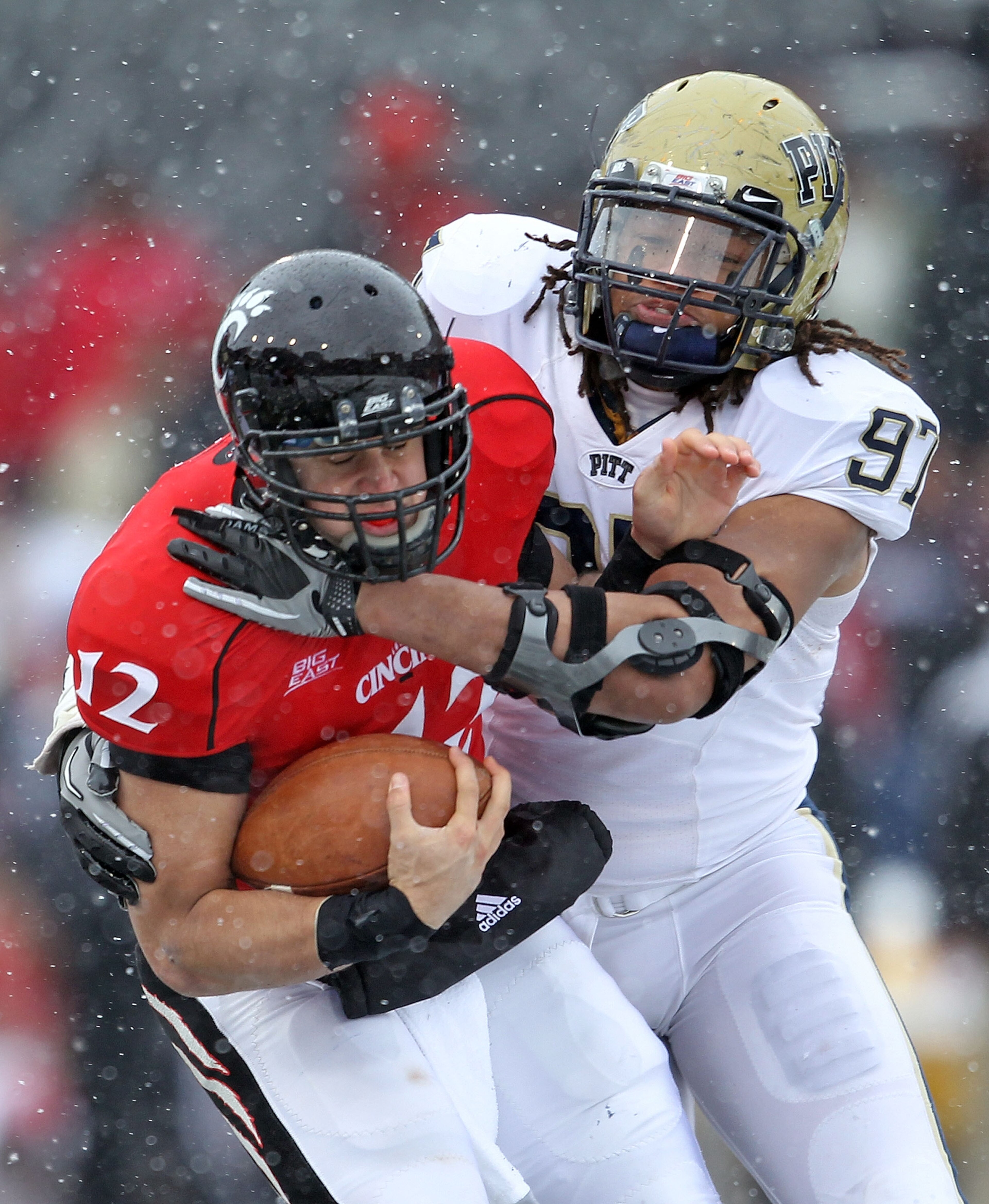 CINCINNATI, OH - DECEMBER 04: Jabaal Sheard #97 of the Pittsburgh Panthers tackles Zach Collaros #12 of the Cincinnati Bearcats during the Big East Conference game against at Nippert Stadium on December 4, 2010 in Cincinnati, Ohio.  Pittsburgh won 28-10.