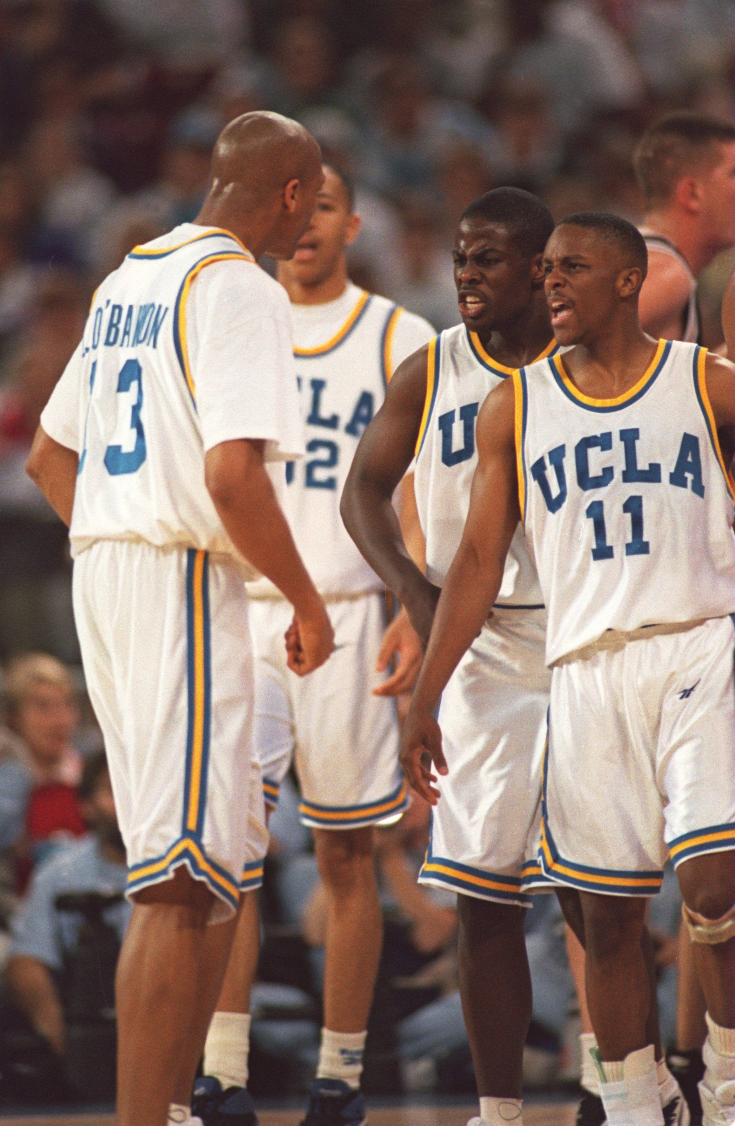 UCLA PLAYERS (FROM LEFT) TYUS EDNEY #11 AND CAMERON DOLLAR #12 CONGRATULATE CHARLES O''BANNON #13 DURING THE FIRST HALF OF THEIR NCAA FINAL FOUR GAME VERSUS OKLAHOMA STATE AT THE KINGDOME IN SEATTLE, WASHINGTON. UCLA WON 74-61 AND ADVANCES TO THE CHAMPION