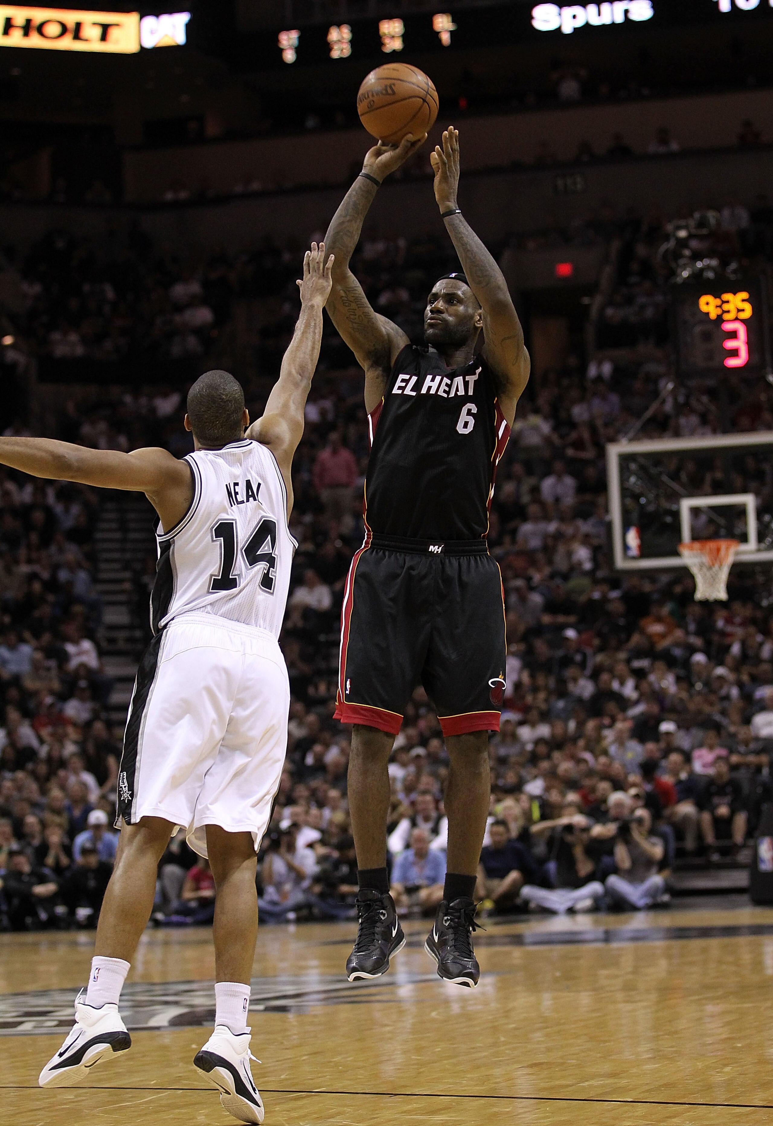SAN ANTONIO, TX - MARCH 04:  Forward LeBron James #6 of the Miami Heat takes a shot against Gary Neal #14 of the San Antonio Spurs at AT&T Center on March 4, 2011 in San Antonio, Texas.   NOTE TO USER: User expressly acknowledges and agrees that, by downl