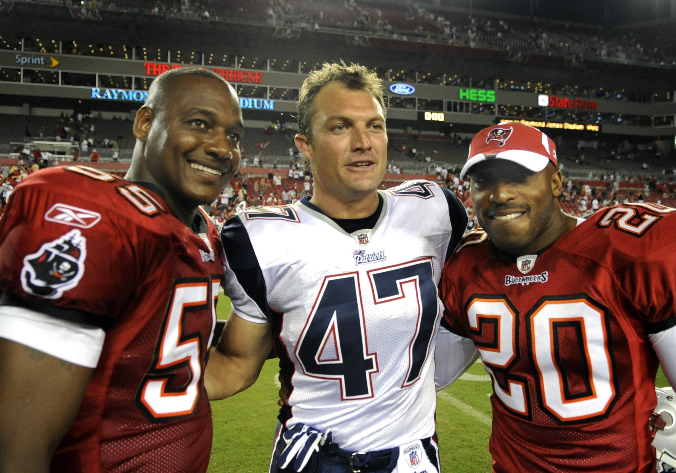 TAMPA, FL - AUGUST 17: Defensive back John Lynch #47 of the New England Patriots greets former Tampa Bay Buccaneers teammates Derrick Brooks #55 and Ronde Barber #20 after play at Raymond James Stadium on August 17, 2008 in Tampa, Florida.   (Photo by Al