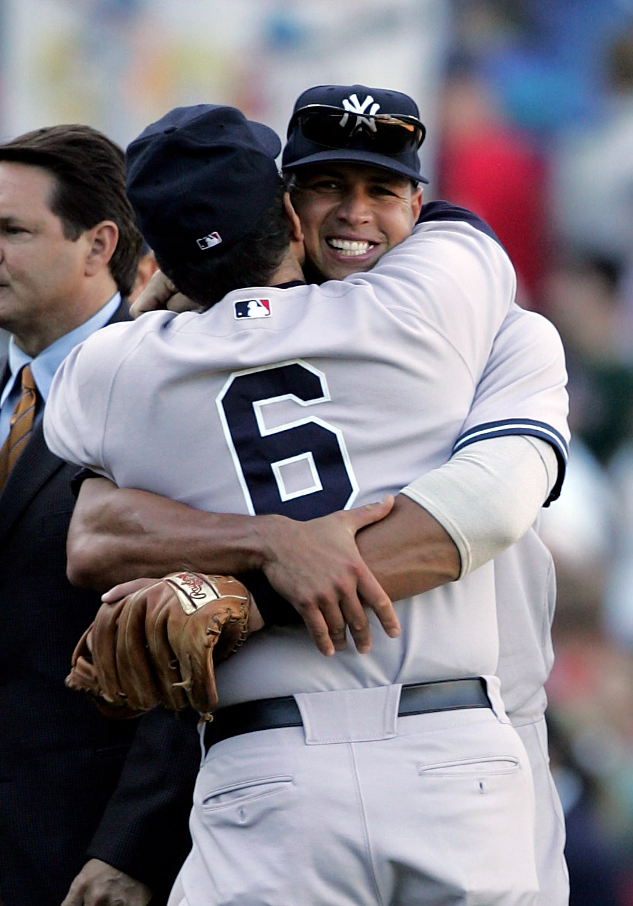 BOSTON - OCTOBER 01:  Alex Rodriguez #13 of the New York Yankees hugs manager, Joe Torre, after winning the game against the Boston Red Sox at Fenway Park on October 1, 2005 in Boston, Massachusetts. The Yankees won the game 8-4.  (Photo by Jim McIsaac/Ge