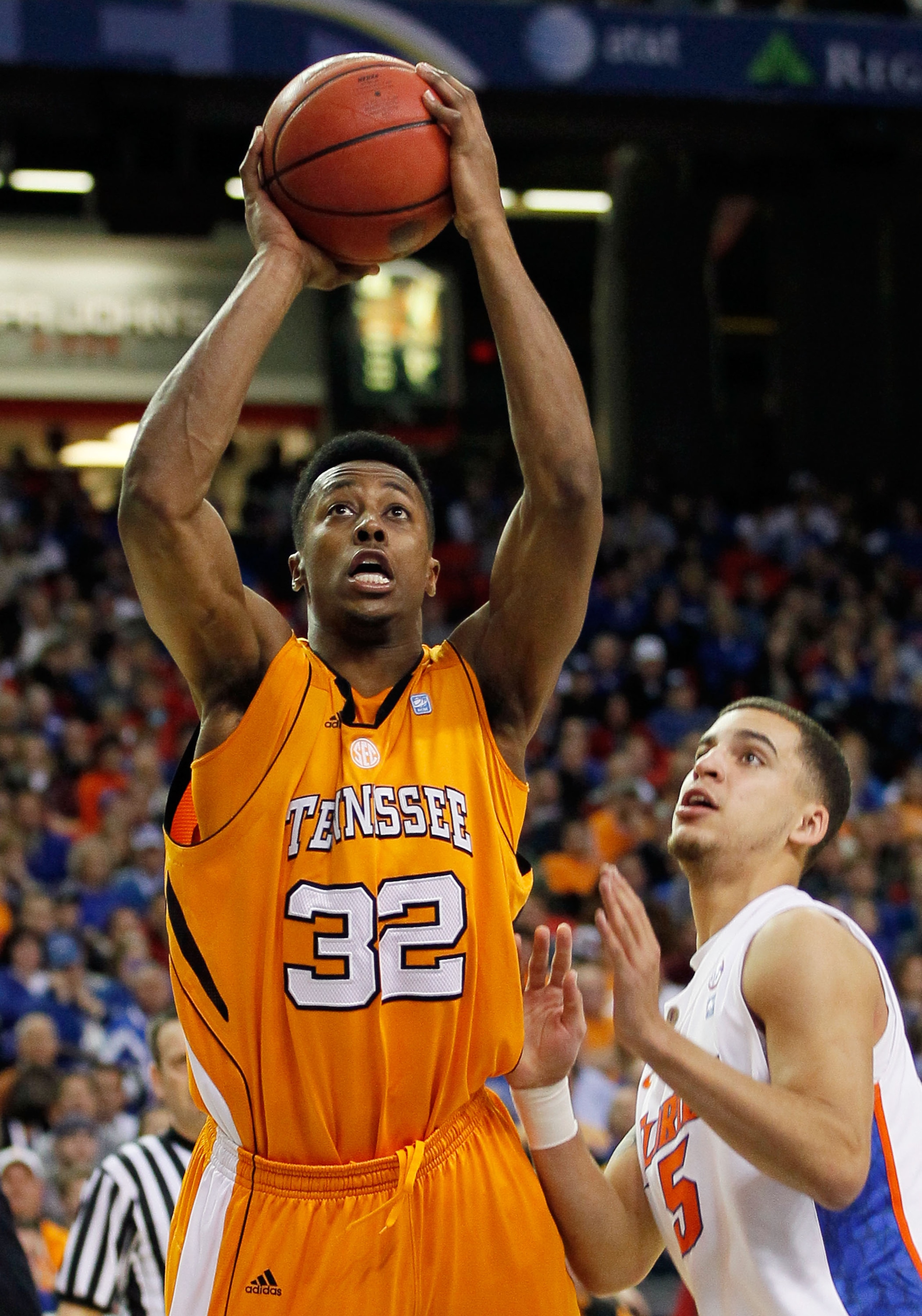 ATLANTA, GA - MARCH 11:  Scotty Hopson #32 of the Tennessee Volunteers shoots over Scottie Wilbekin #5 of the Florida Gators during the quarterfinals of the SEC Men's Basketball Tournament at Georgia Dome on March 11, 2011 in Atlanta, Georgia.  (Photo by