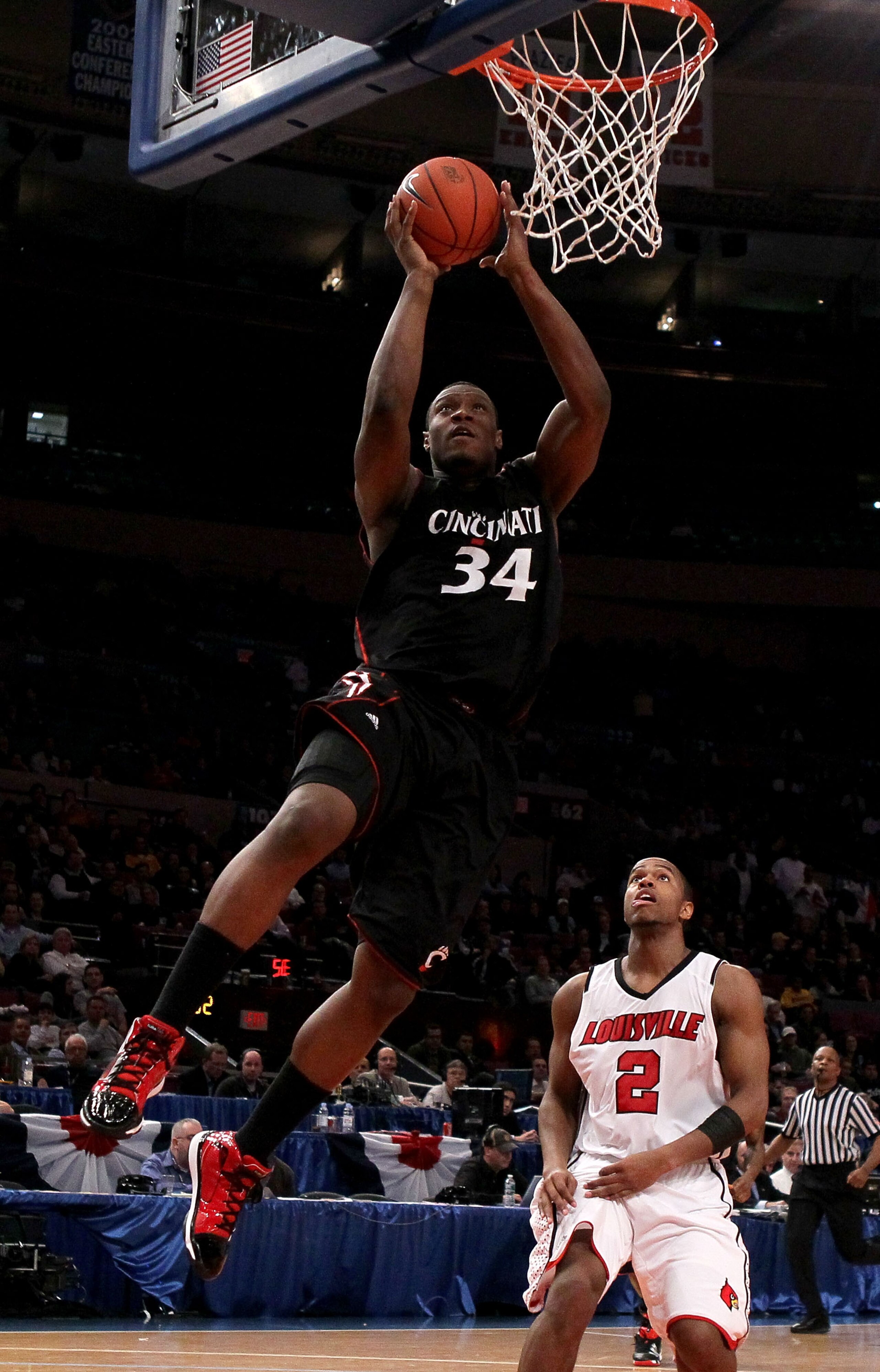 NEW YORK - MARCH 10: Yancy Gates #34 of the Cincinnati Bearcats goes to the hoop against Preston Knowles #2 of the Louisville Cardinals during the second round of 2010 NCAA Big East Tournament at Madison Square Garden on March 10, 2010 in New York City.