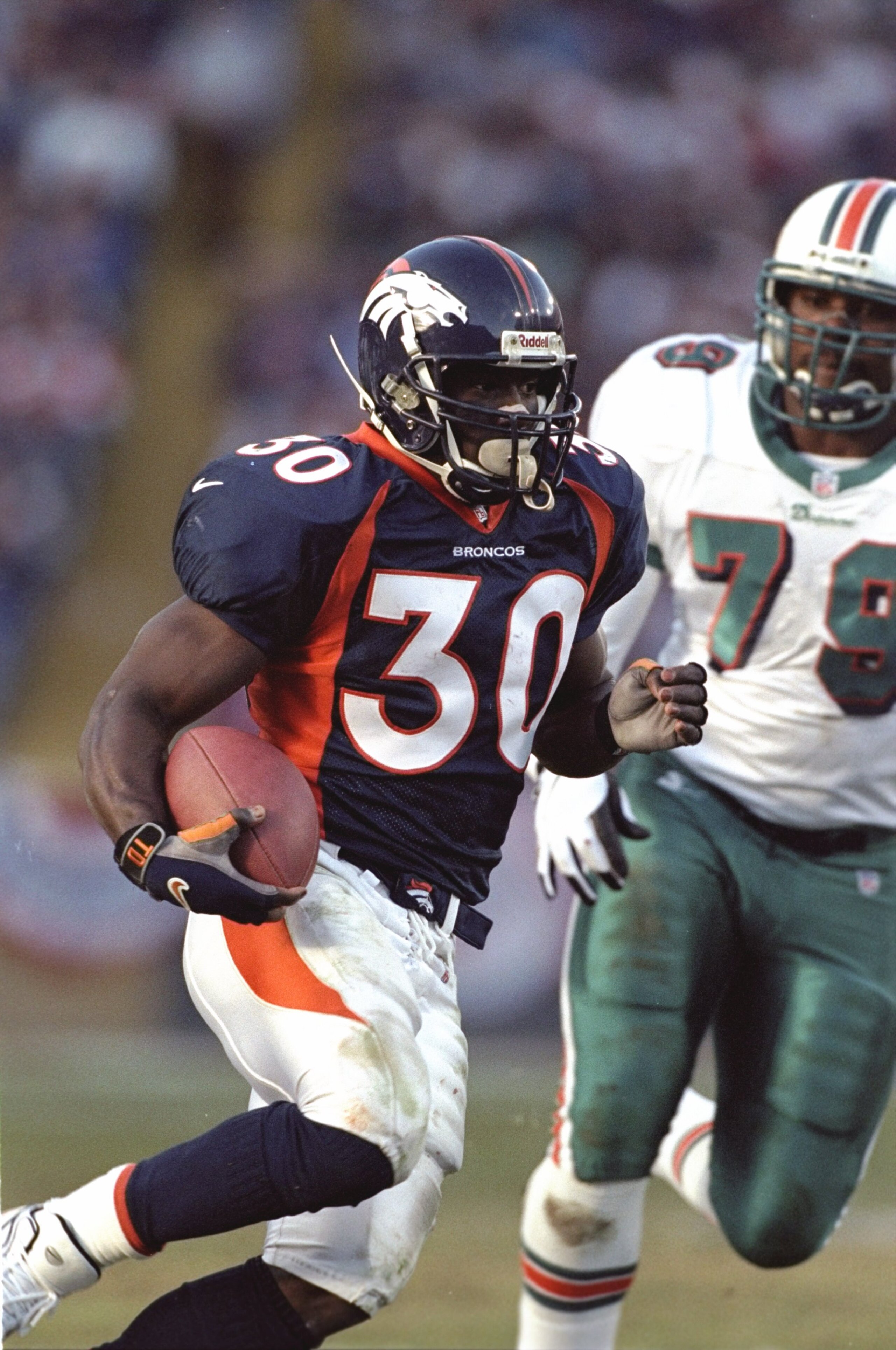 9 Jan 1999: Terrell Davis #30 of the Denver Broncos carries the ball during the AFC Play Offs against the Miami Dolphins at Mile High Stadium in Denver, Colorado. The Broncos defeated the Dolphins 38-3. Mandatory Credit: Brian Bahr  /Allsport