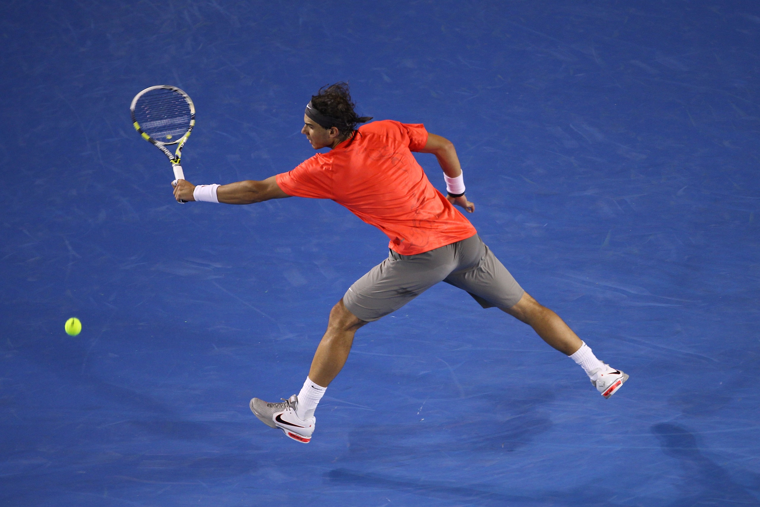 MELBOURNE, AUSTRALIA - JANUARY 26:  Rafael Nadal of Spain plays a backhand in his quarterfinal match against David Ferrer of Spain during day ten of the 2011 Australian Open at Melbourne Park on January 26, 2011 in Melbourne, Australia.  (Photo by Julian