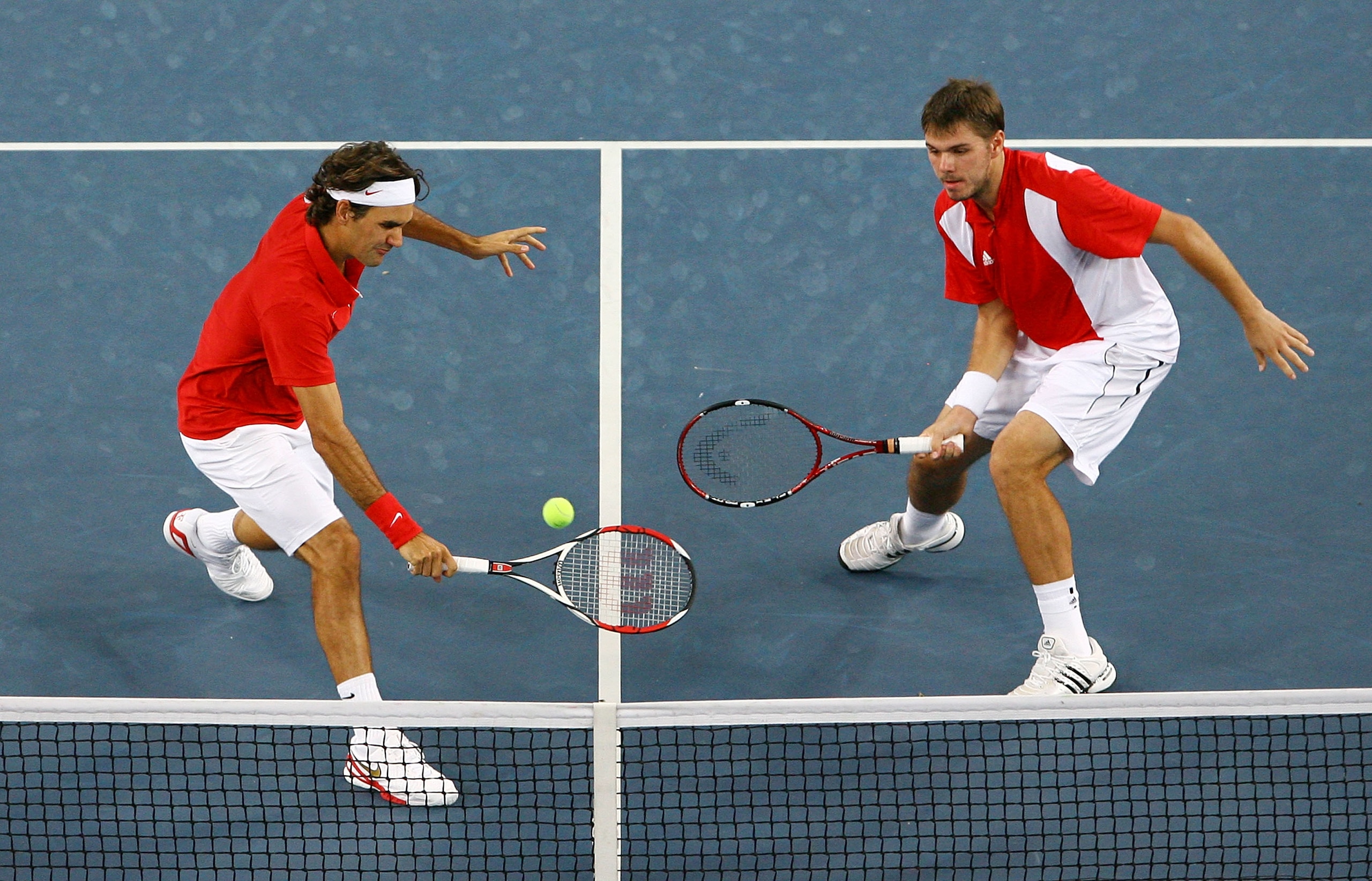 BEIJING - AUGUST 16:  Roger Federer (left) and Stanislas Wawrinka of Switzerland take on Thomas Johansson and Simon Aspelin of Sweden during the men's doubles gold medal tennis match at the Olympic Green Tennis Center on Day 8 of the Beijing 2008 Olympic