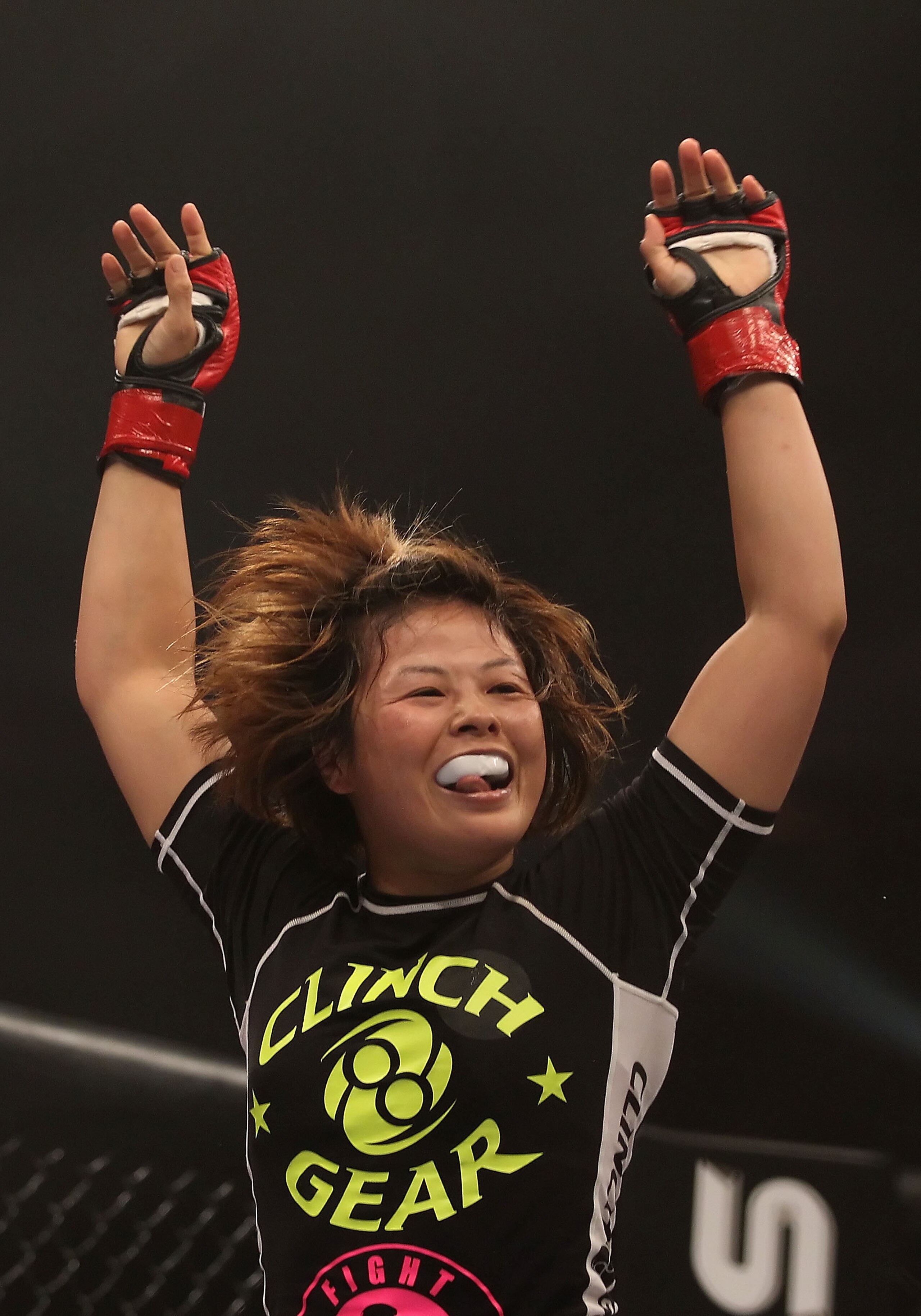 PHOENIX - AUGUST 13:  Hitomi Akano of Japan celebrates after defeating Carina Damm (not pictured) in the Strikeforce Women's Welterweight Tournament semi final bout at Dodge Theater on August 13, 2010 in Phoenix, Arizona.  (Photo by Christian Petersen/Get
