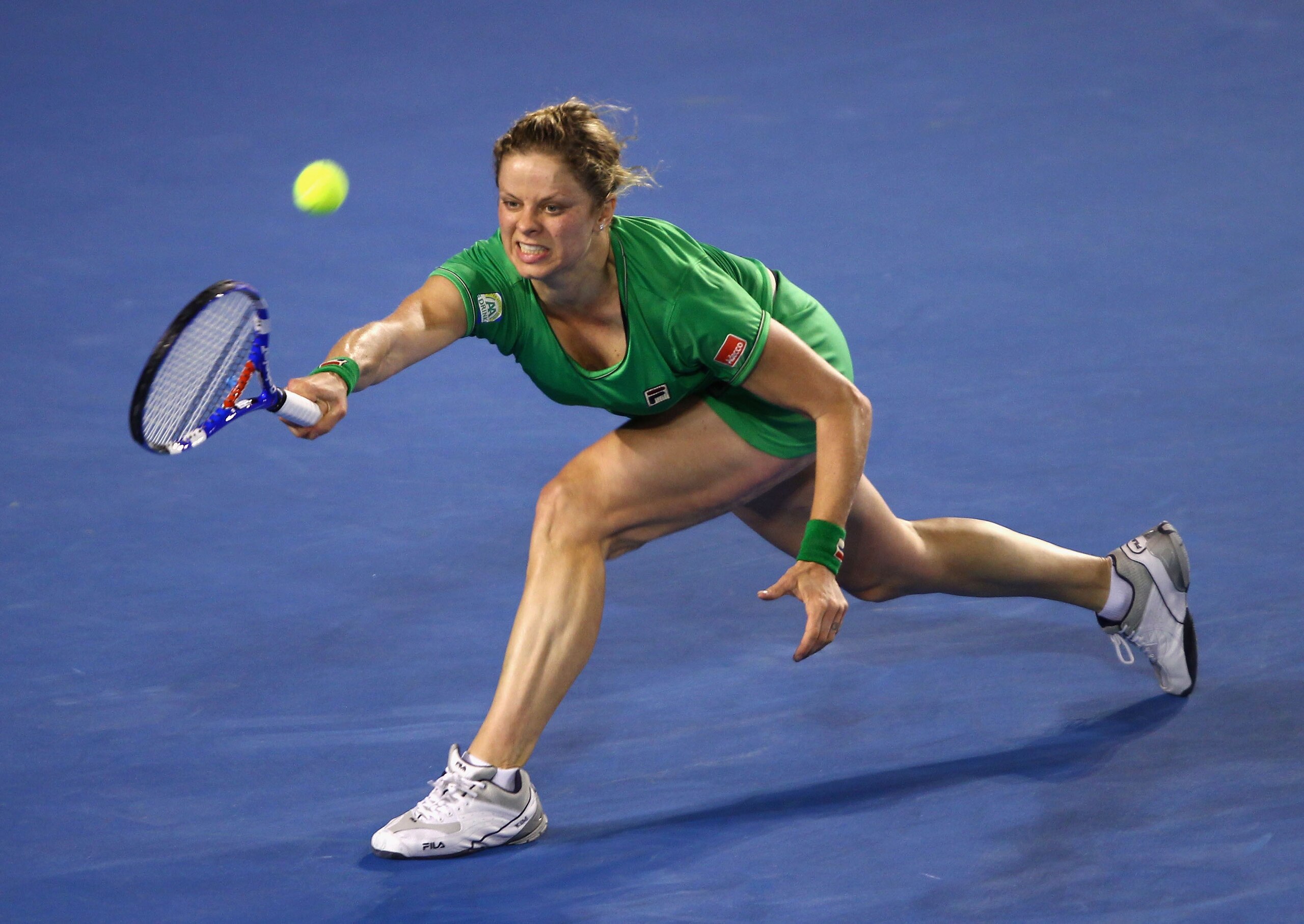 MELBOURNE, AUSTRALIA - JANUARY 29:  Kim Clijsters of Belgium stretches to play a forehand in her women's final match against Na Li of China during day thirteen of the 2011 Australian Open at Melbourne Park on January 29, 2011 in Melbourne, Australia.  (Ph