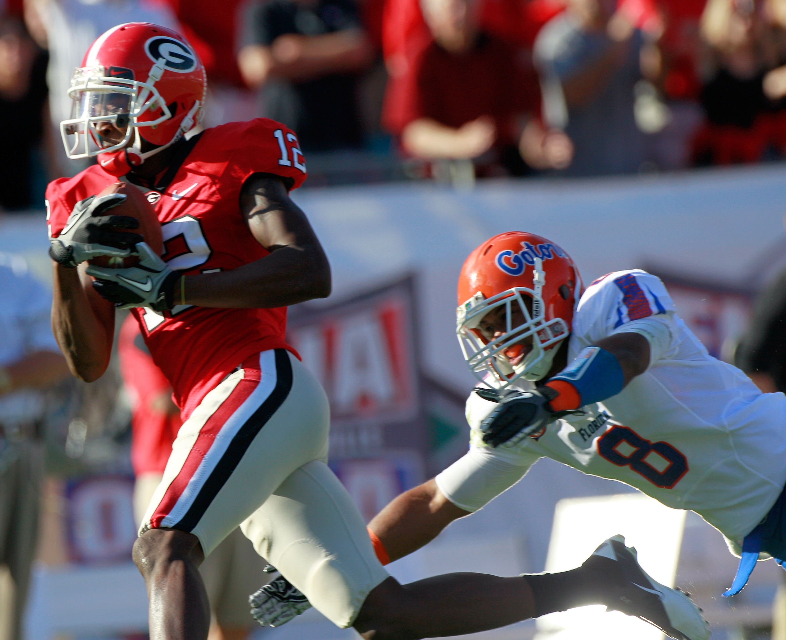 JACKSONVILLE, FL - OCTOBER 30:  Jeremy Brown #8 of the Florida Gators attempts to tackle Tavarres King #12 of the Georgia Bulldogs during the game at EverBank Field on October 30, 2010 in Jacksonville, Florida.  (Photo by Sam Greenwood/Getty Images)