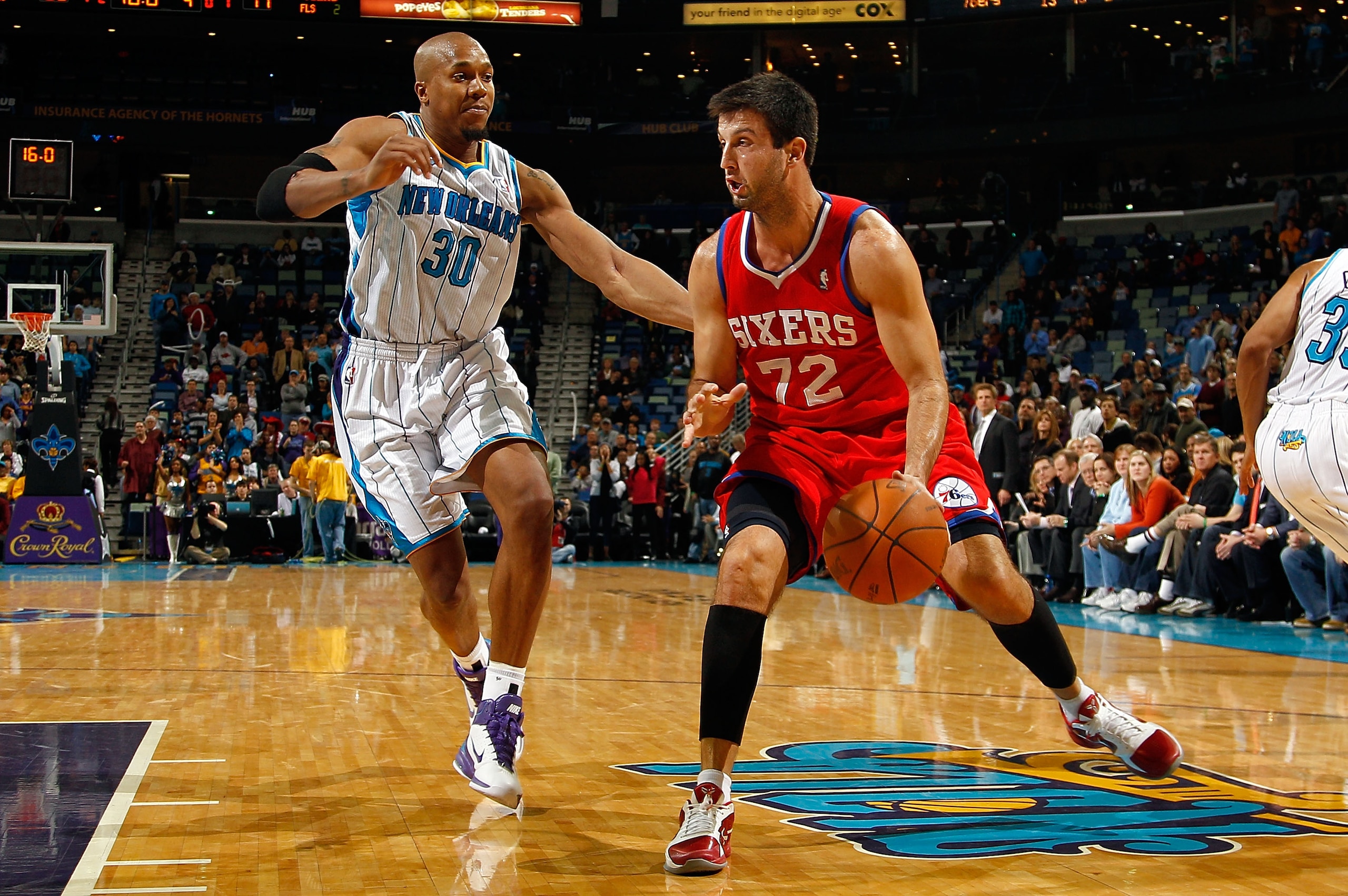NEW ORLEANS, LA - JANUARY 03:  Jason Kapono #72 of the Philadelphia 76ers moves the ball against David West #30 of the New Orleans Hornets at New Orleans Arena on January 3, 2011 in New Orleans, Louisiana. NOTE TO USER: User expressly acknowledges and agr