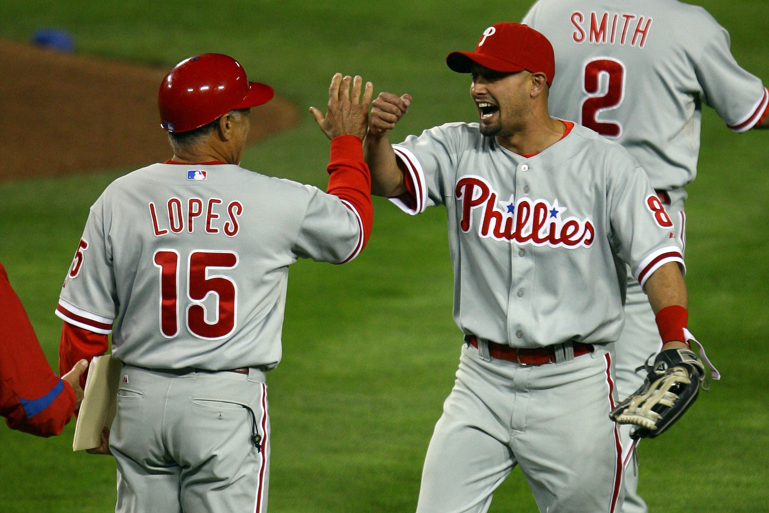 LOS ANGELES, CA - OCTOBER 13:  (R) Shane Victorino #8 of the Philadelphia Phillies celebrates with coach Davey Lopes #15 after defeating the Los Angeles Dodgers 7-5 in Game Four of the National League Championship Series during the 2008 MLB playoffs on Oc