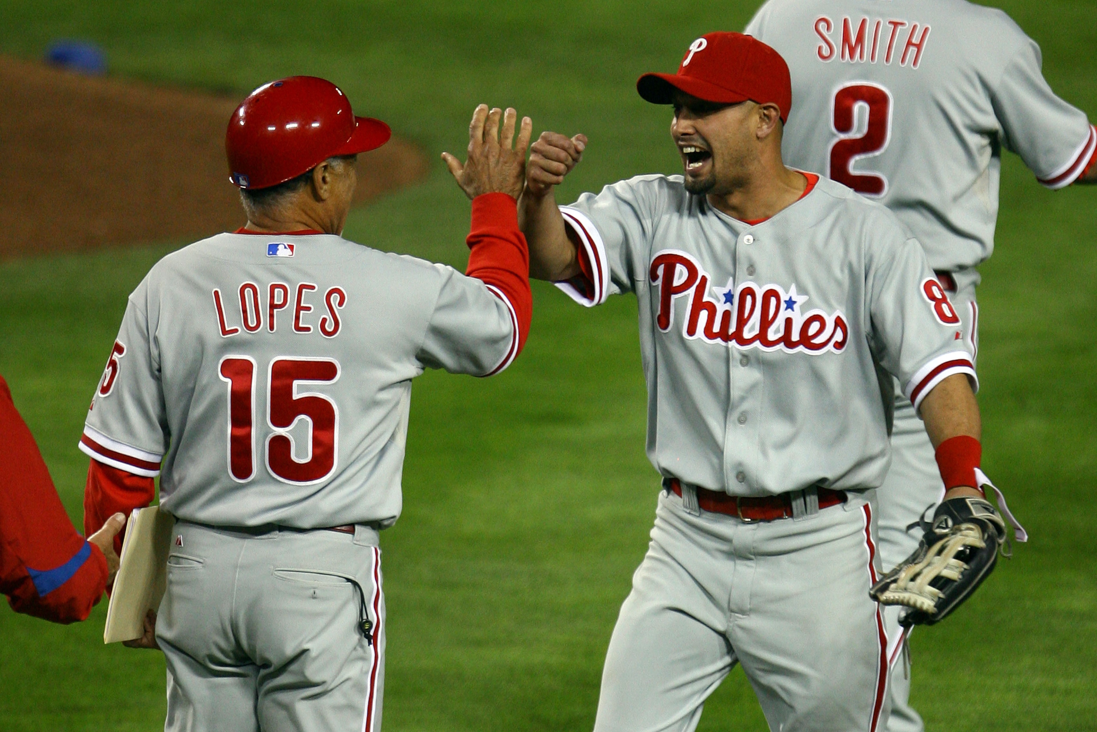 LOS ANGELES, CA - OCTOBER 13:  (R) Shane Victorino #8 of the Philadelphia Phillies celebrates with coach Davey Lopes #15 after defeating the Los Angeles Dodgers 7-5 in Game Four of the National League Championship Series during the 2008 MLB playoffs on Oc