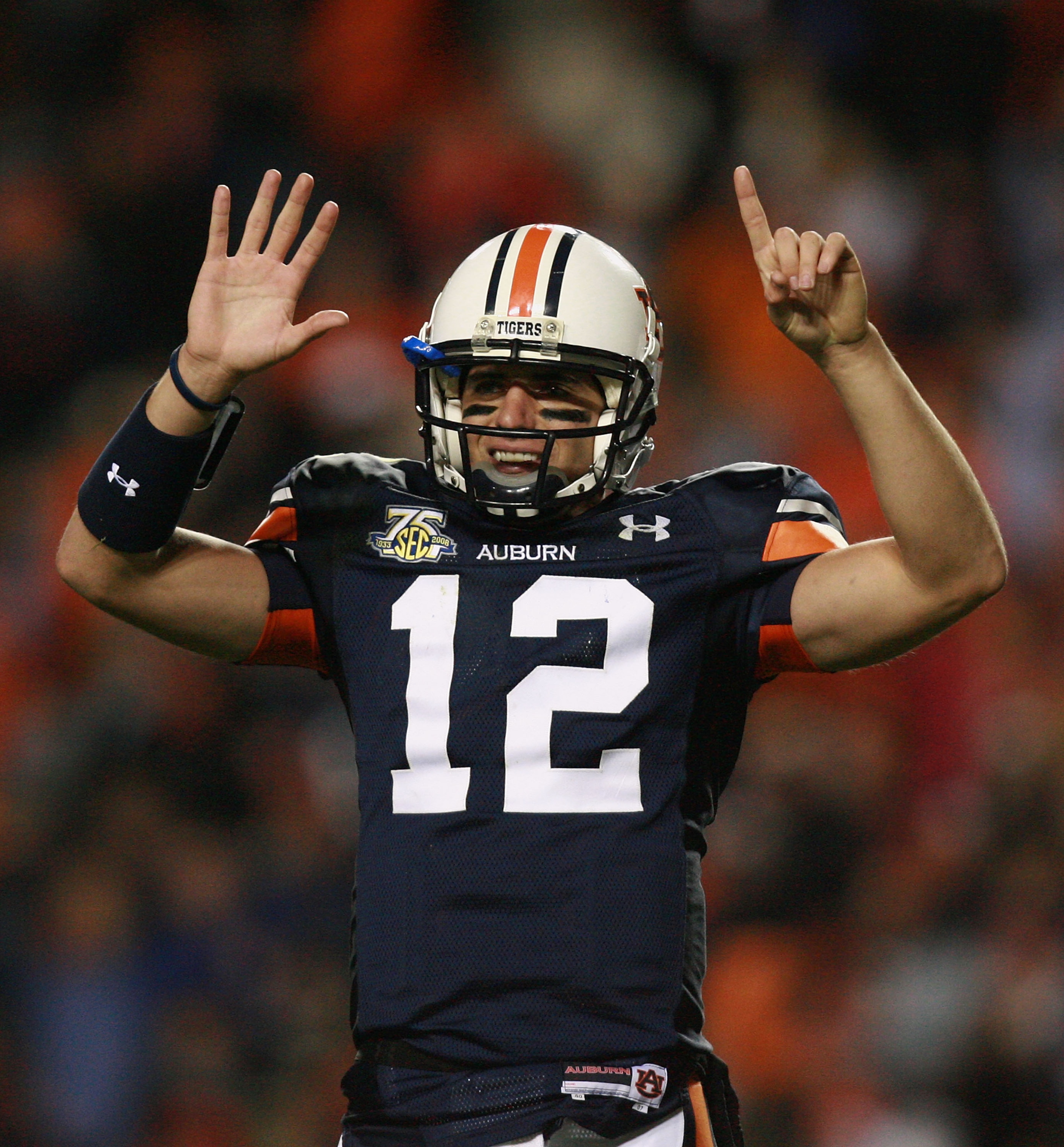 AUBURN, AL - NOVEMBER 24:  Quarterback Brandon Cox #12 of the Auburn Tigers holds up six fingers celebrating their sixth straight victory over Alabama, after picking up a first down with less than a minute to play in the game against the Alabama Crimson T
