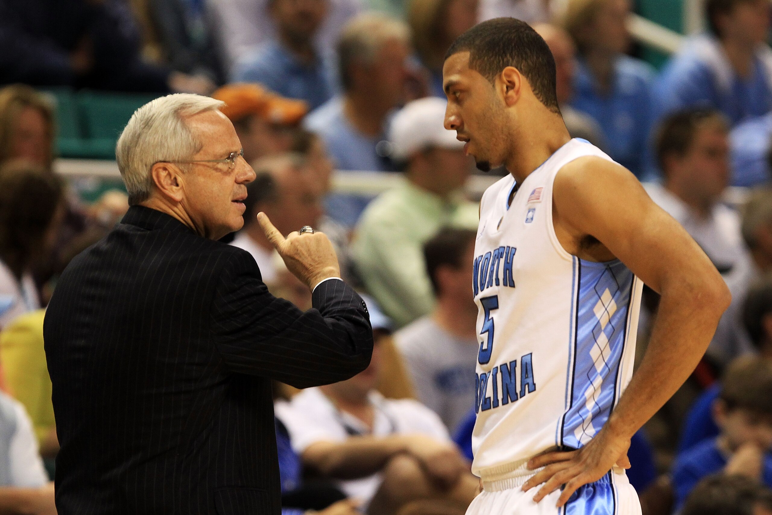 GREENSBORO, NC - MARCH 12:  Head coach Roy Williams of the North Carolina Tar Heels talks with Kendall Marshall #5 while playing against the Clemson Tigers in the semifinals of the 2011 ACC men's basketball tournament at the Greensboro Coliseum on March 1