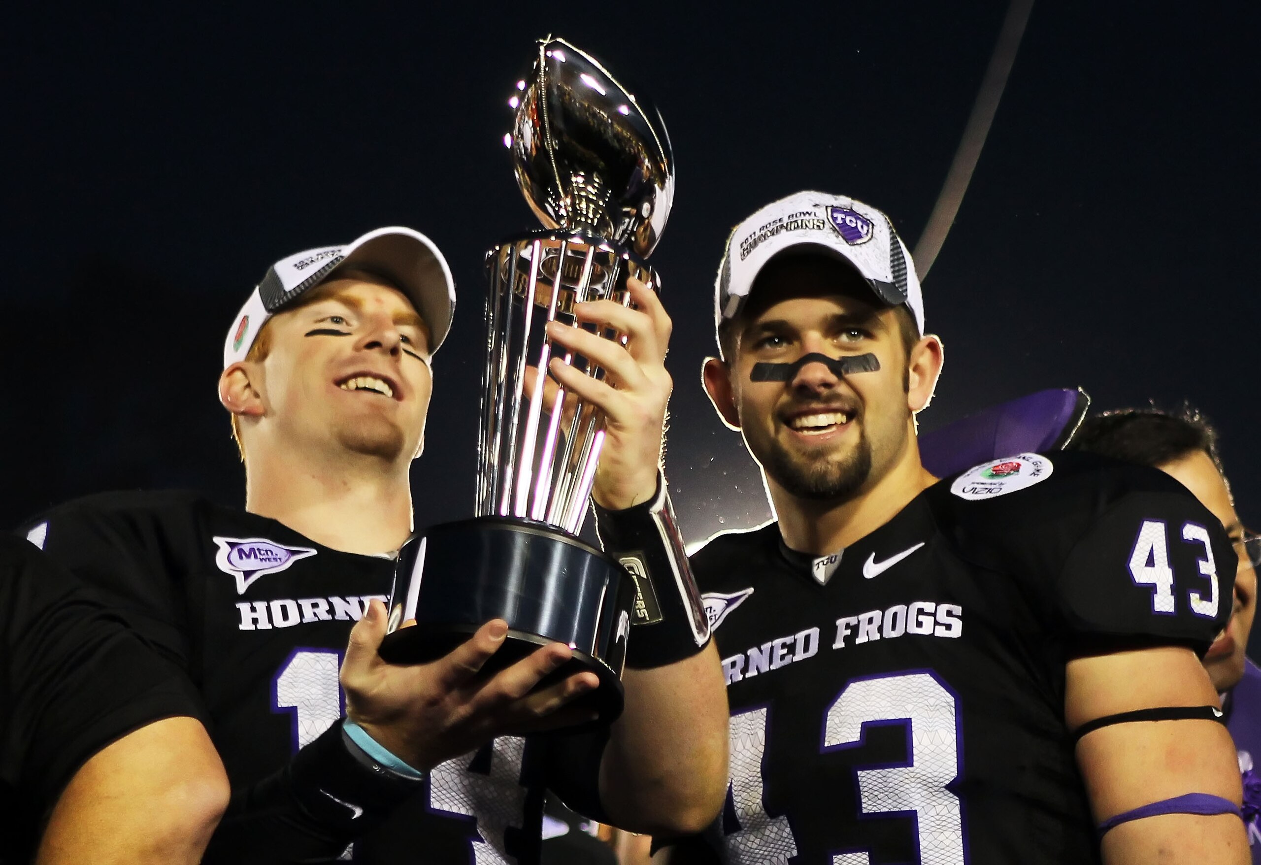 PASADENA, CA - JANUARY 01:  Quarterback Andy Dalton #14 and linebacker Tank Carder #43 of the TCU Horned Frogs hold the Rose Bowl Championship Trophy after defeating the Wisconsin Badgers 21-19 in the 97th Rose Bowl game on January 1, 2011 in Pasadena, Ca