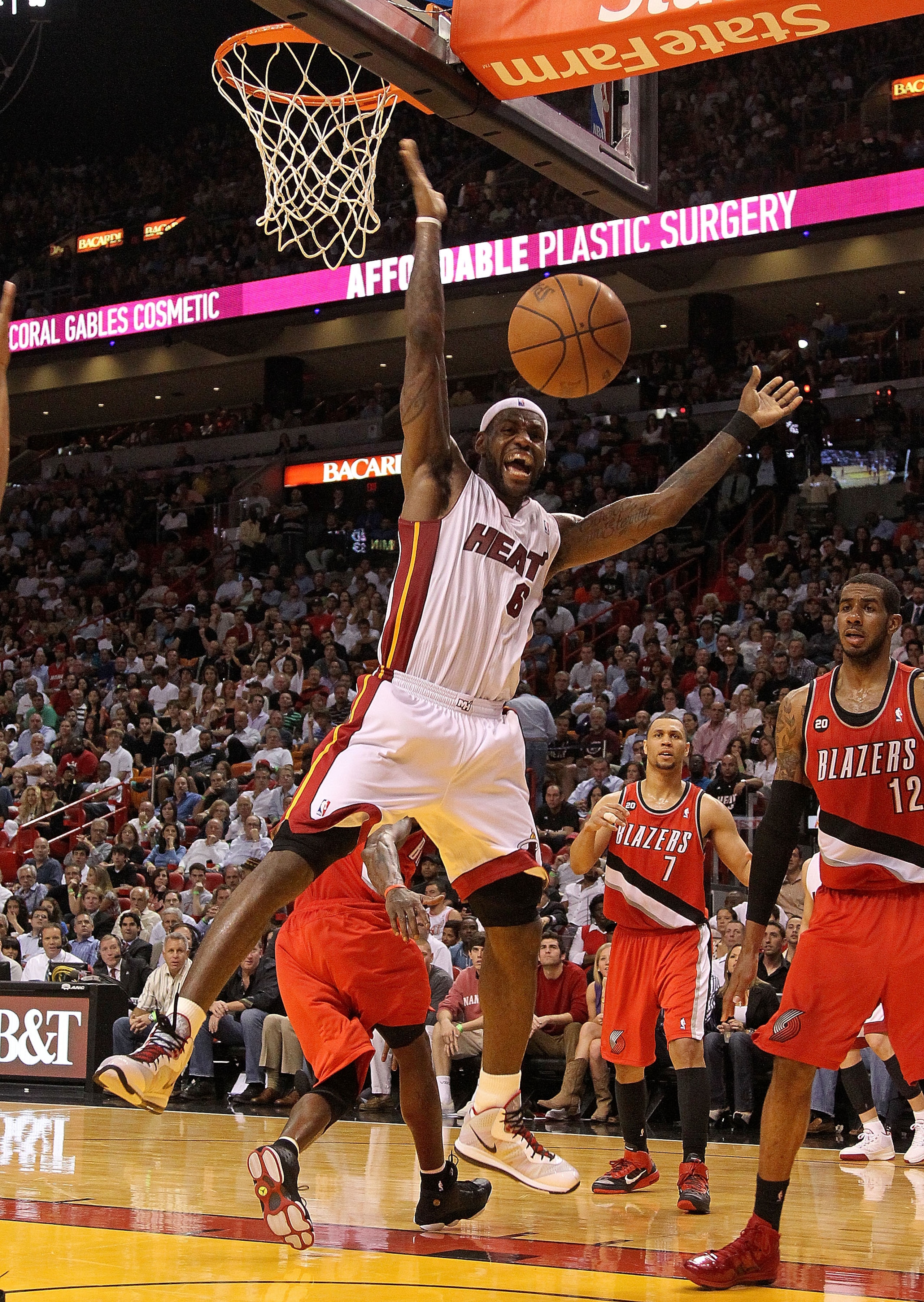 MIAMI, FL - MARCH 08:  LeBron James #6 of the Miami Heat is fouled during a game against the Portland Trail Blazers at American Airlines Arena on March 8, 2011 in Miami, Florida. NOTE TO USER: User expressly acknowledges and agrees that, by downloading an