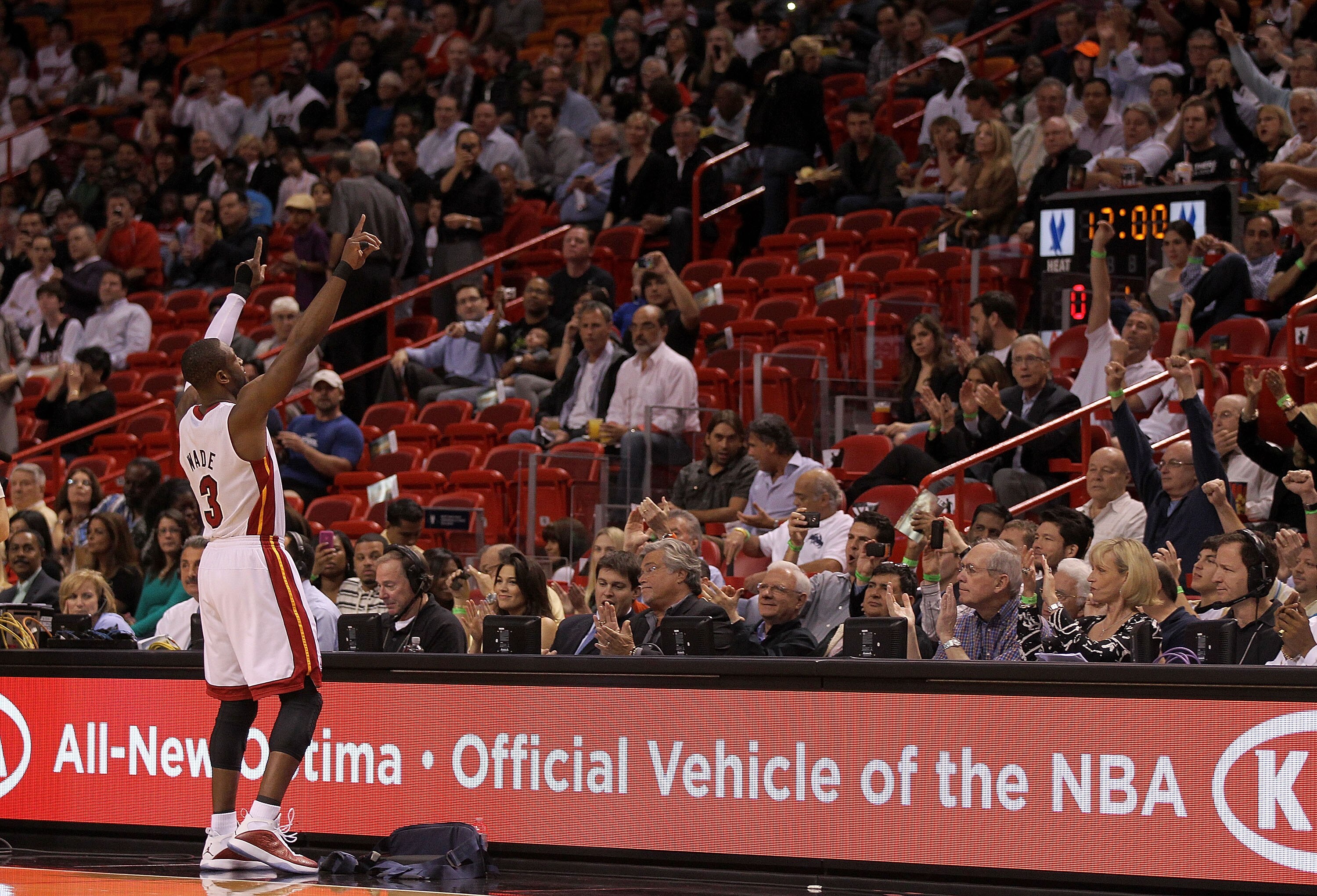 MIAMI, FL - JANUARY 31:  Dwyane Wade #3 of the Miami Heat greets fans during a game against the Cleveland Cavaliers at American Airlines Arena on January 31, 2011 in Miami, Florida. NOTE TO USER: User expressly acknowledges and agrees that, by downloading