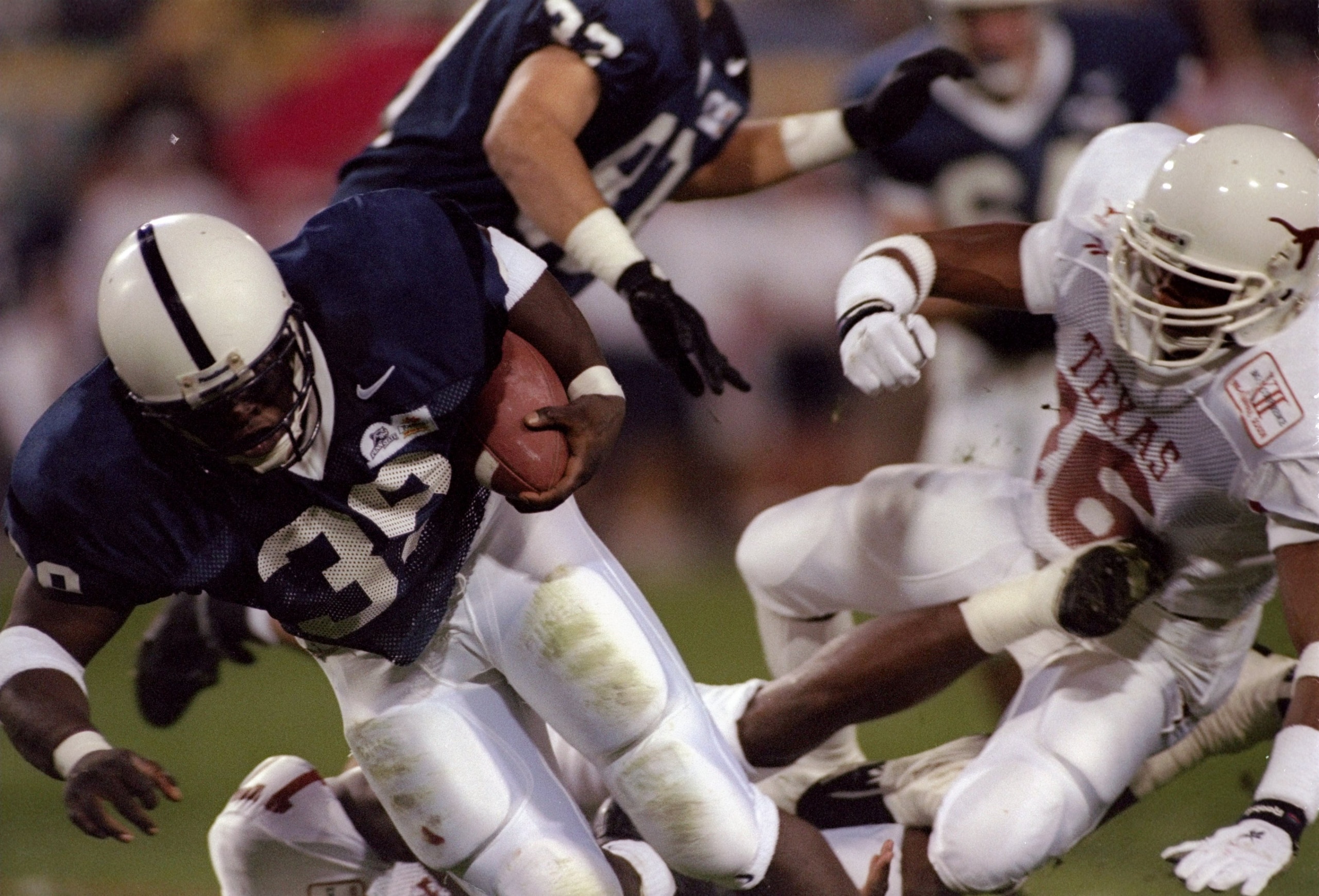 1 Jan 1997: Running back Curtis Enis of the Penn State Nittany Lions gets tackled during the Fiesta Bowl against the the Texas Longhorns at Sun Devil Stadium in Tempe, Arizona. Penn State won the game, 38-15. Mandatory Credit: Todd Warshaw /Allsport 1 Jan 1997: Running back Curtis Enis of the Penn State Nittany Lions gets tackled during the Fiesta Bowl against the the Texas Longhorns at Sun Devil Stadium in Tempe, Arizona. Penn State won the game, 38-15. Mandatory Credit: Todd Warshaw /Allsport
